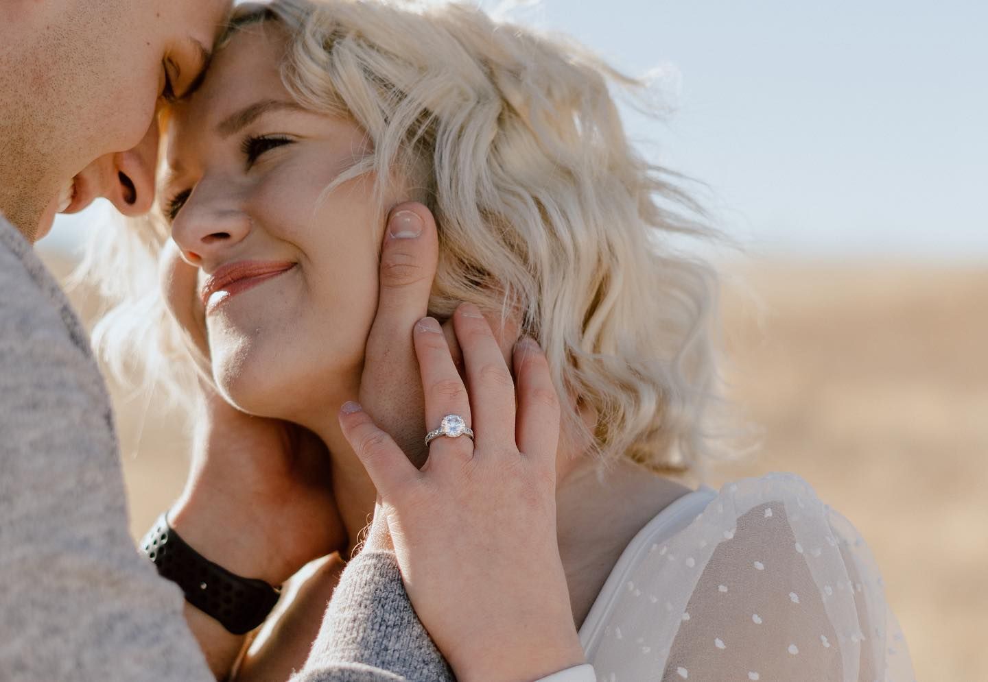 Close-up shots of tender wedding moments against a warm desert backdrop.