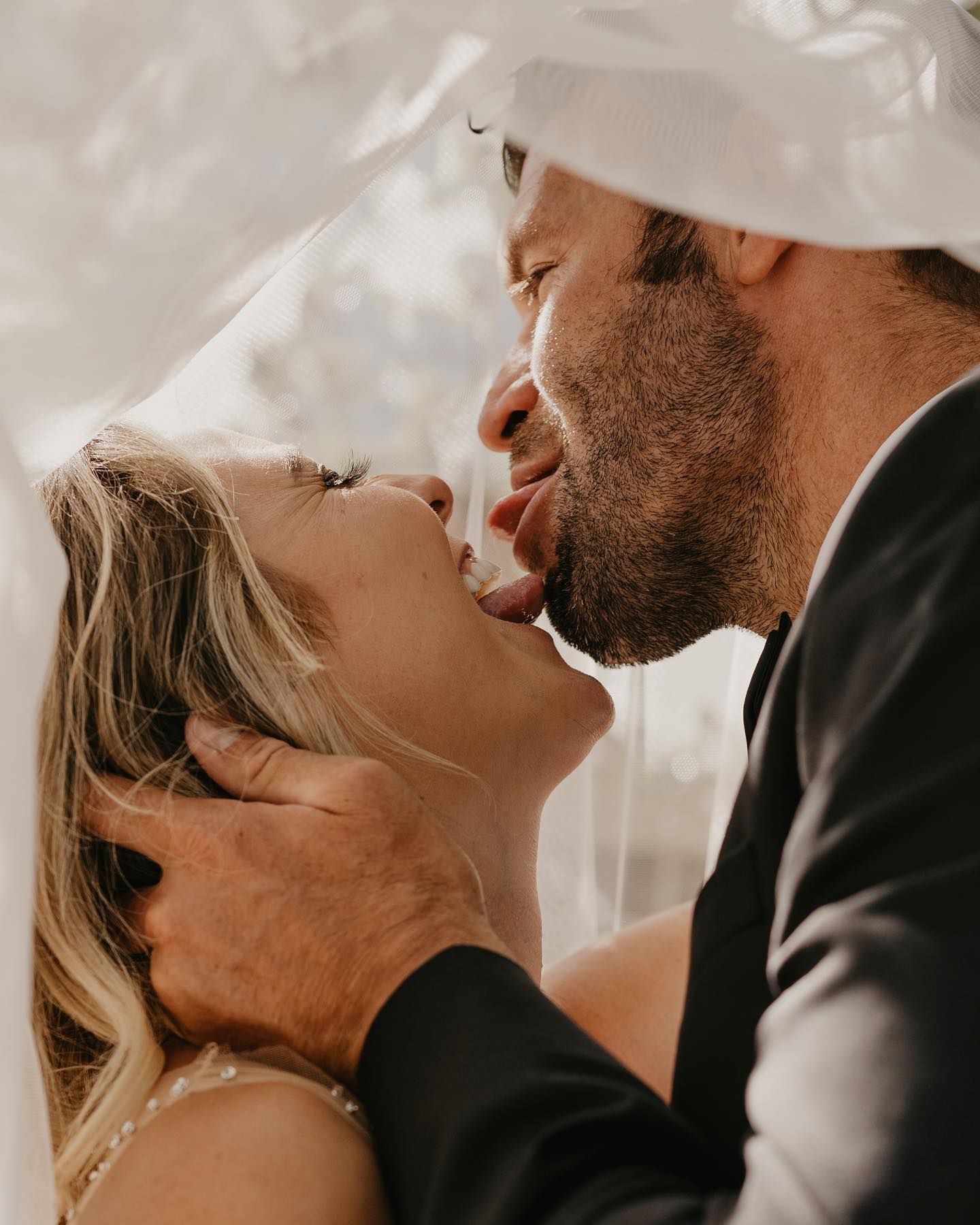 A tender moment shared between a couple surrounded by ethereal smoke or mist.