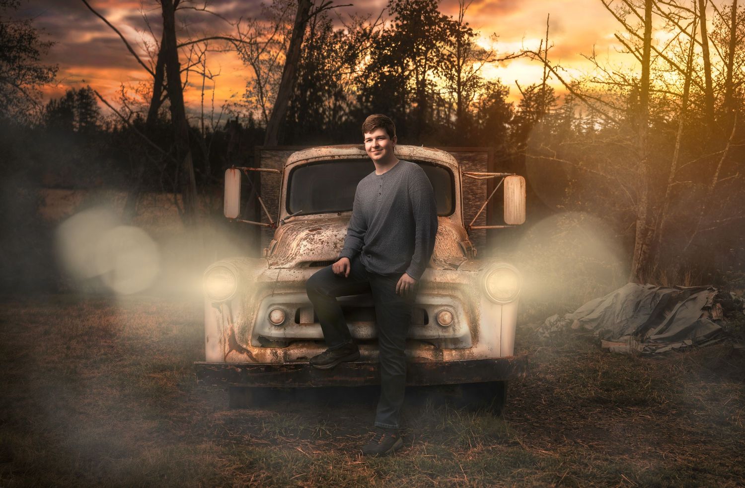 Dramatic sunset landscape with vintage cars and atmospheric fog effects.