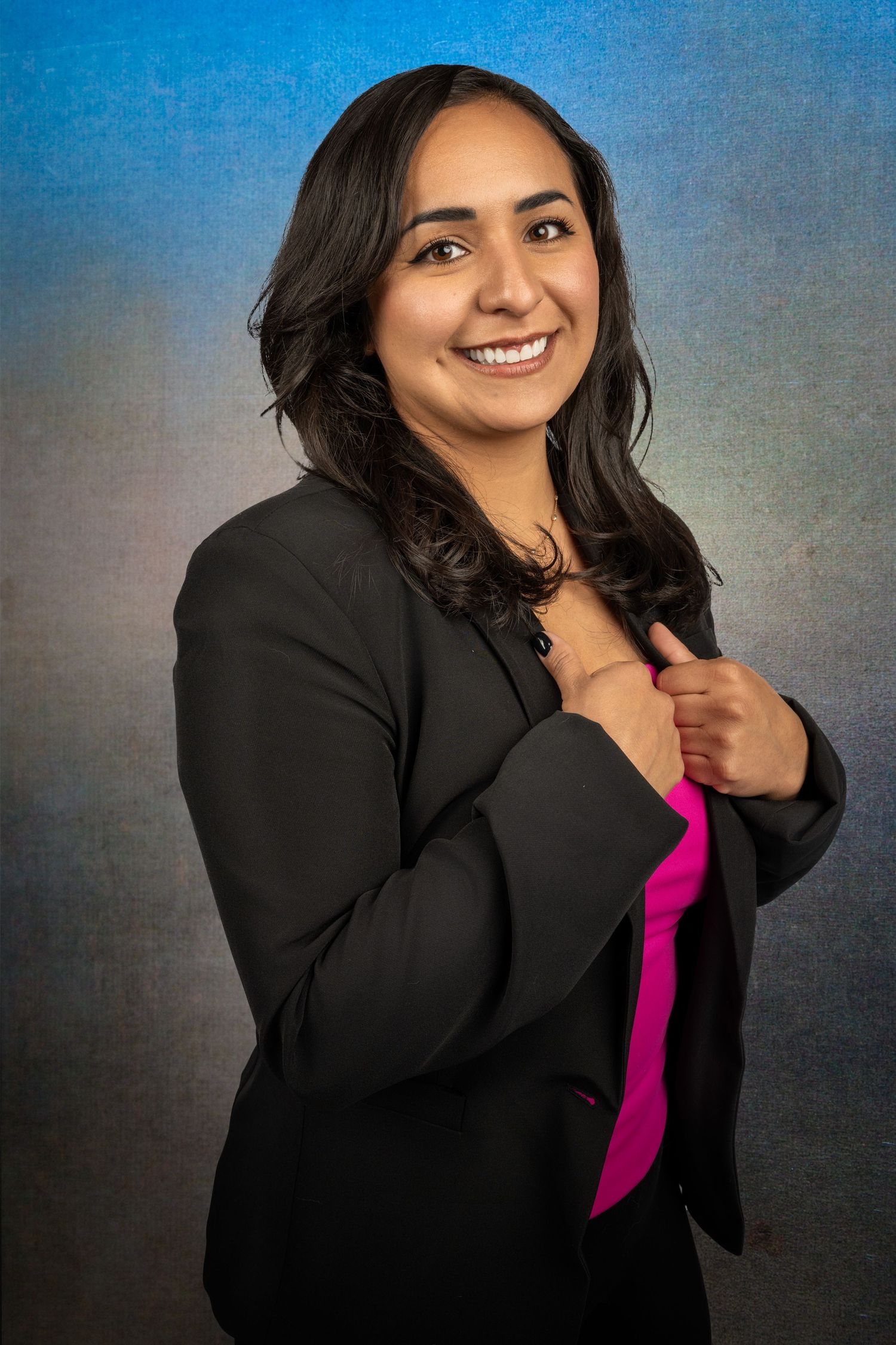 Studio portrait series showing playful expressions against blue-grey backdrop.