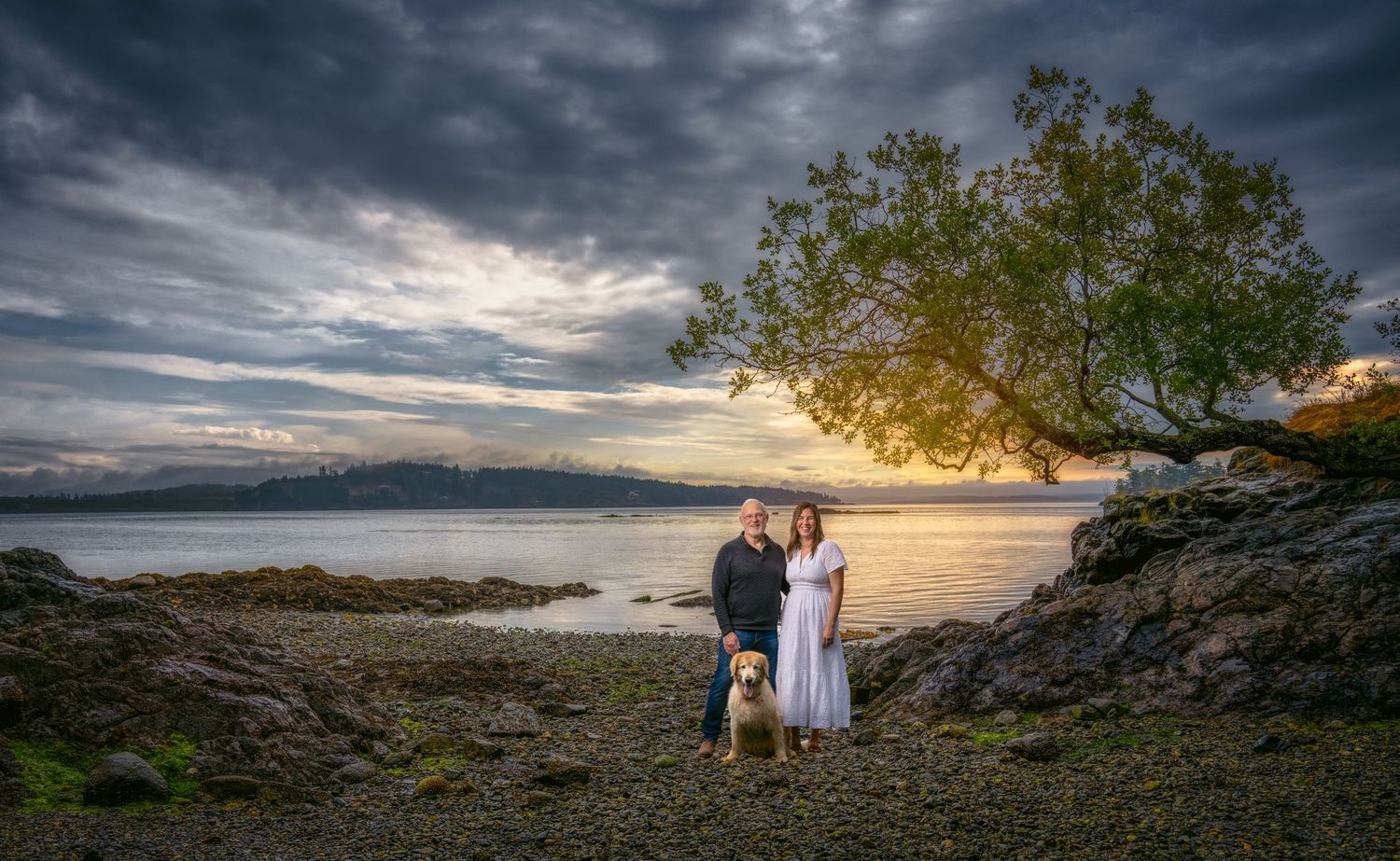 Dramatic coastal landscape photography with stormy skies and rocky shoreline at sunset.