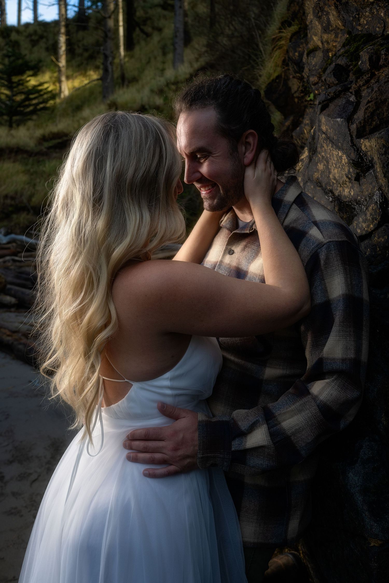 Romantic forest engagement session with soft natural lighting.