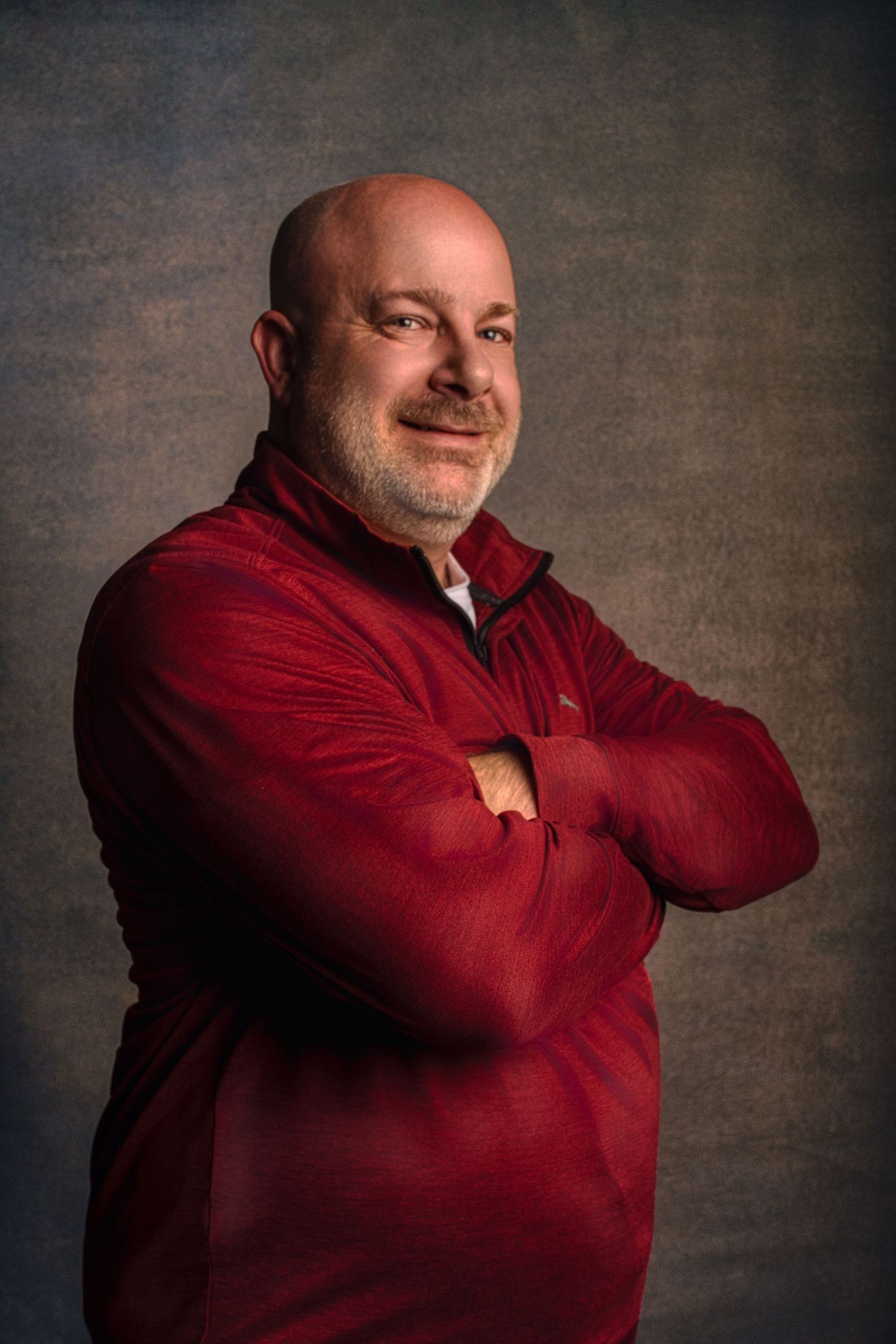 Professional portrait series showing a person in a red sweater against a dark textured background in various poses.