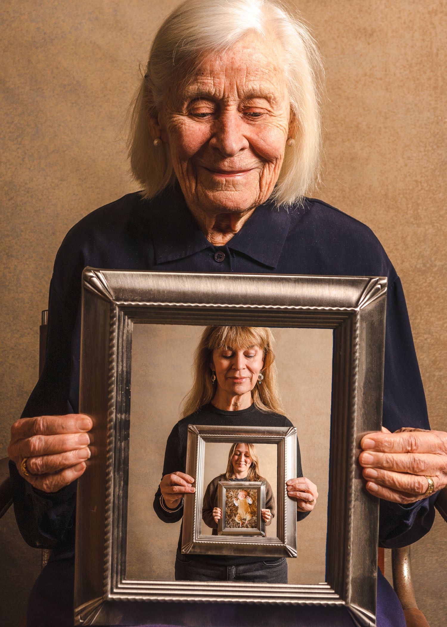 Creative portrait showing multiple nested frames held up in sequence.