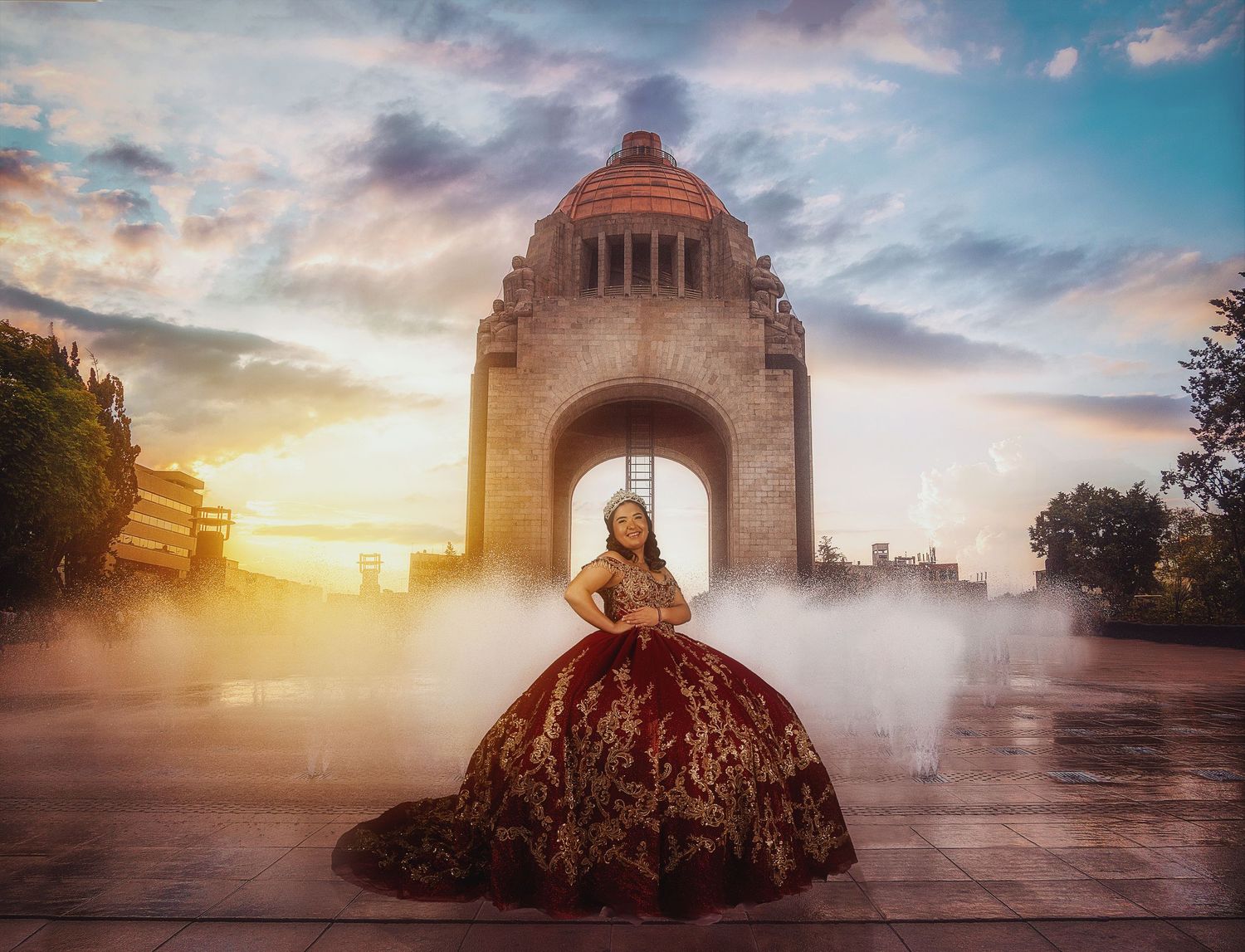 Ornate ball gown silhouette against dramatic monument architecture at sunset.