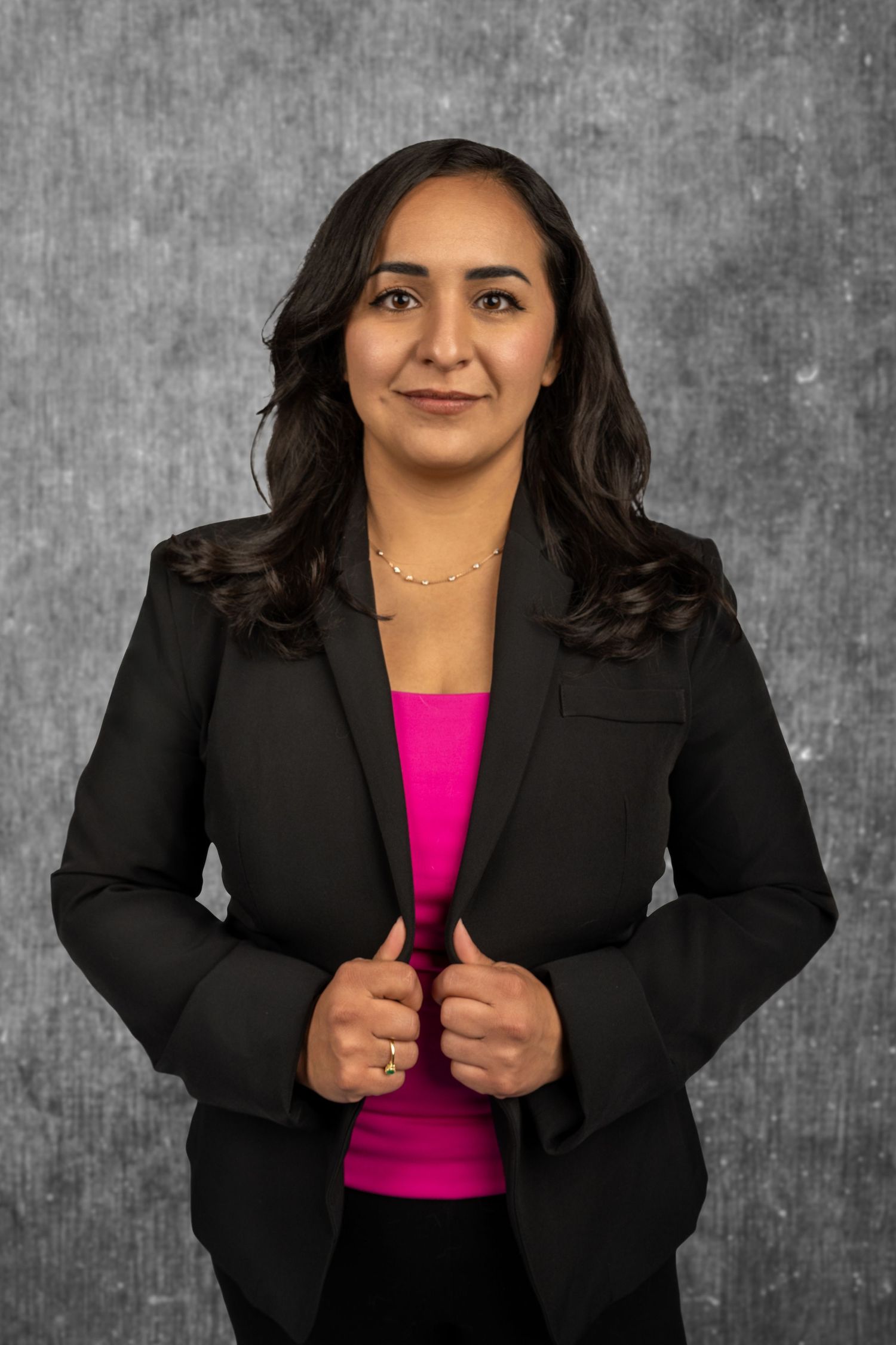 Professional business portrait series showing poses in black blazer and pink top.