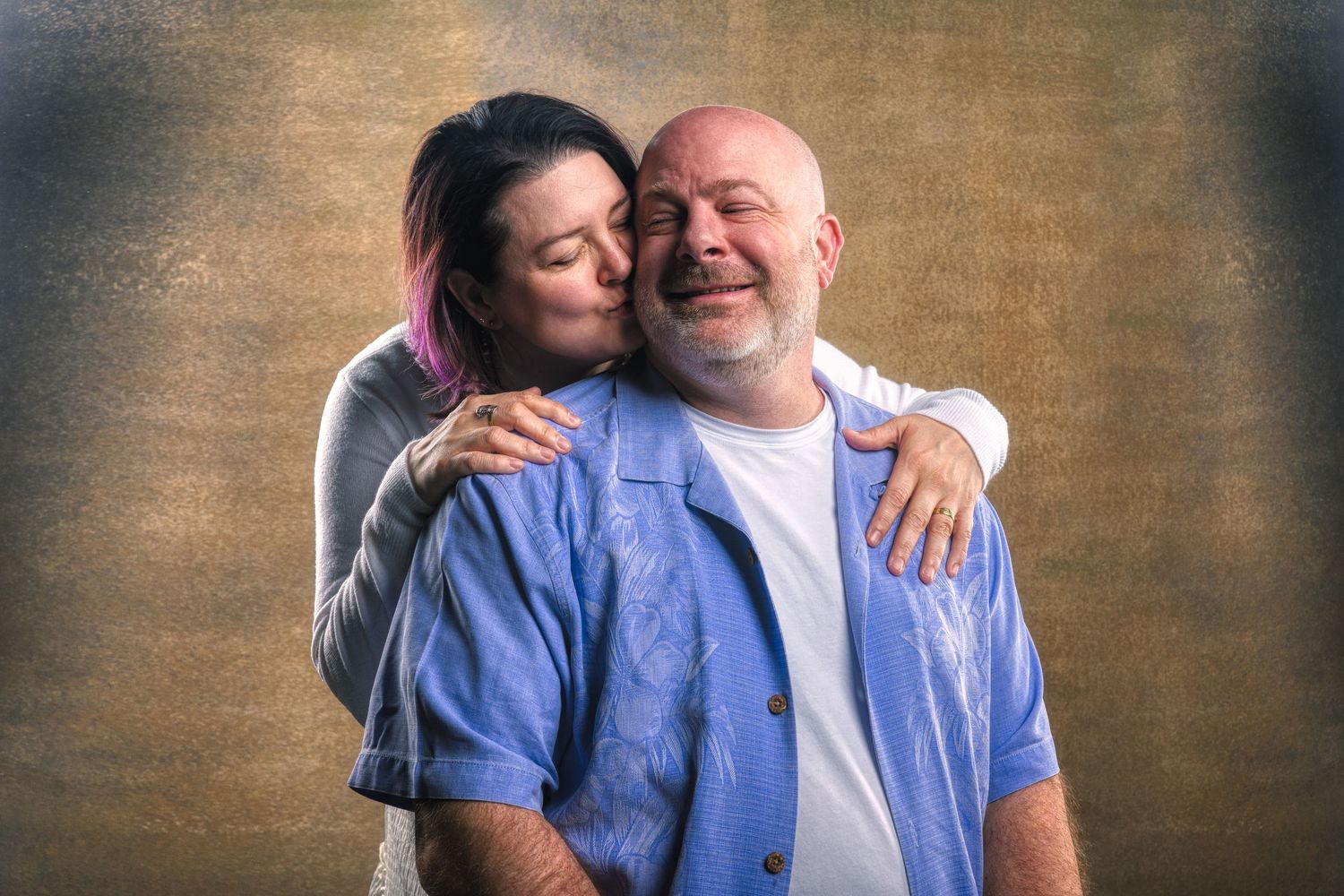 Candid portrait series showing joyful moments between two people against dark background.