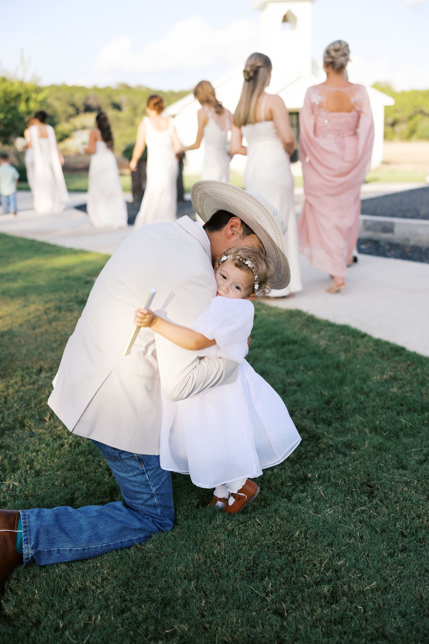 A series of wedding photos showing a couple dancing on green grass during an outdoor celebration.