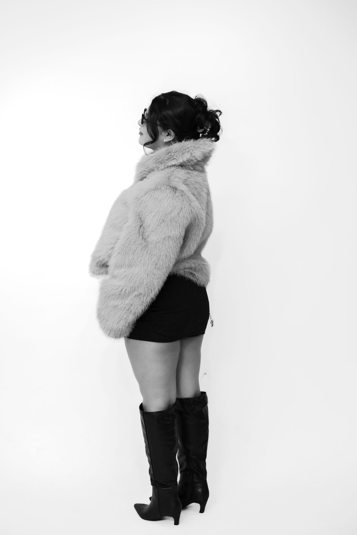 Stylized black and white portraits featuring boots and fur coat.
