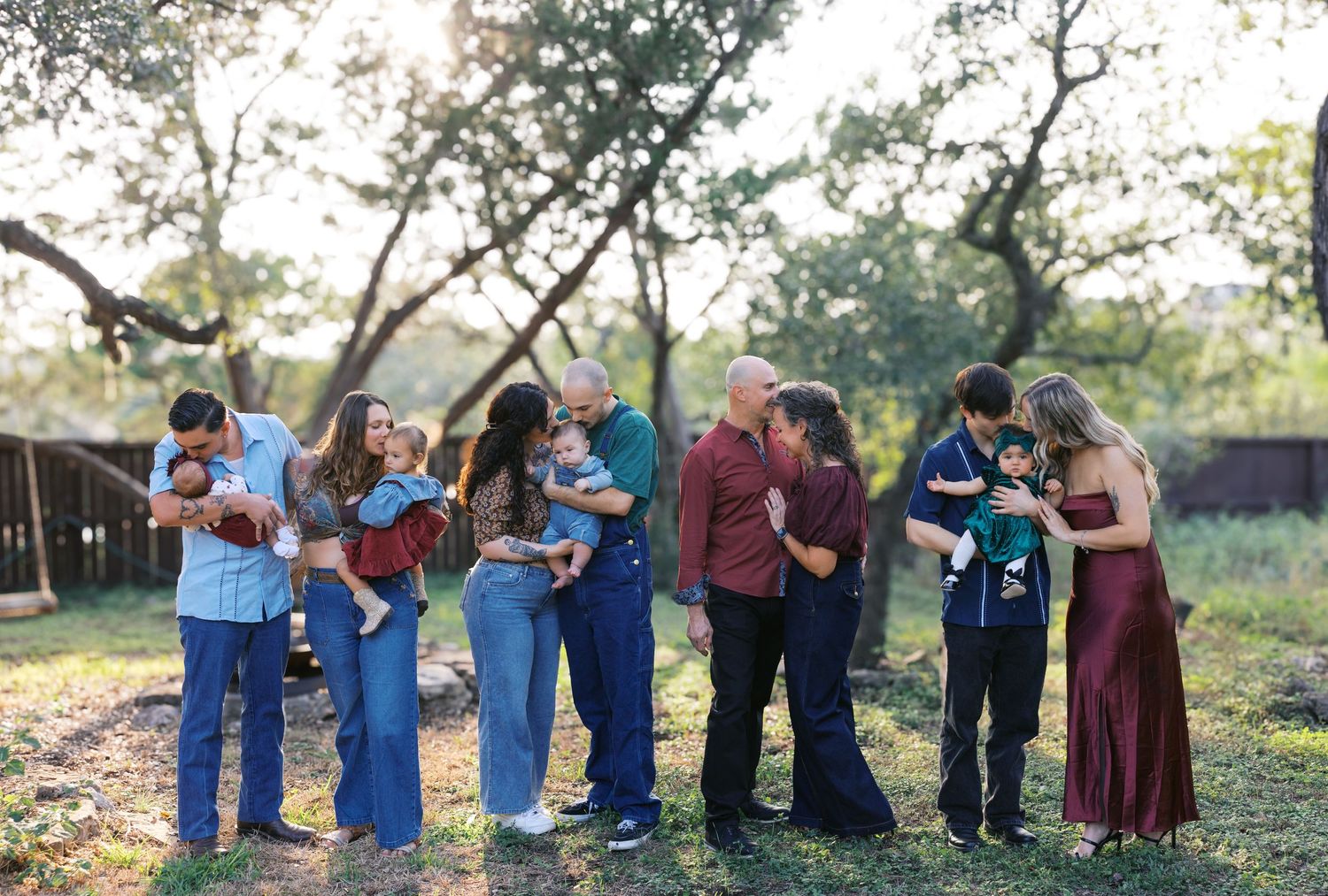 A casual outdoor gathering with people holding books and standing in a line formation.
