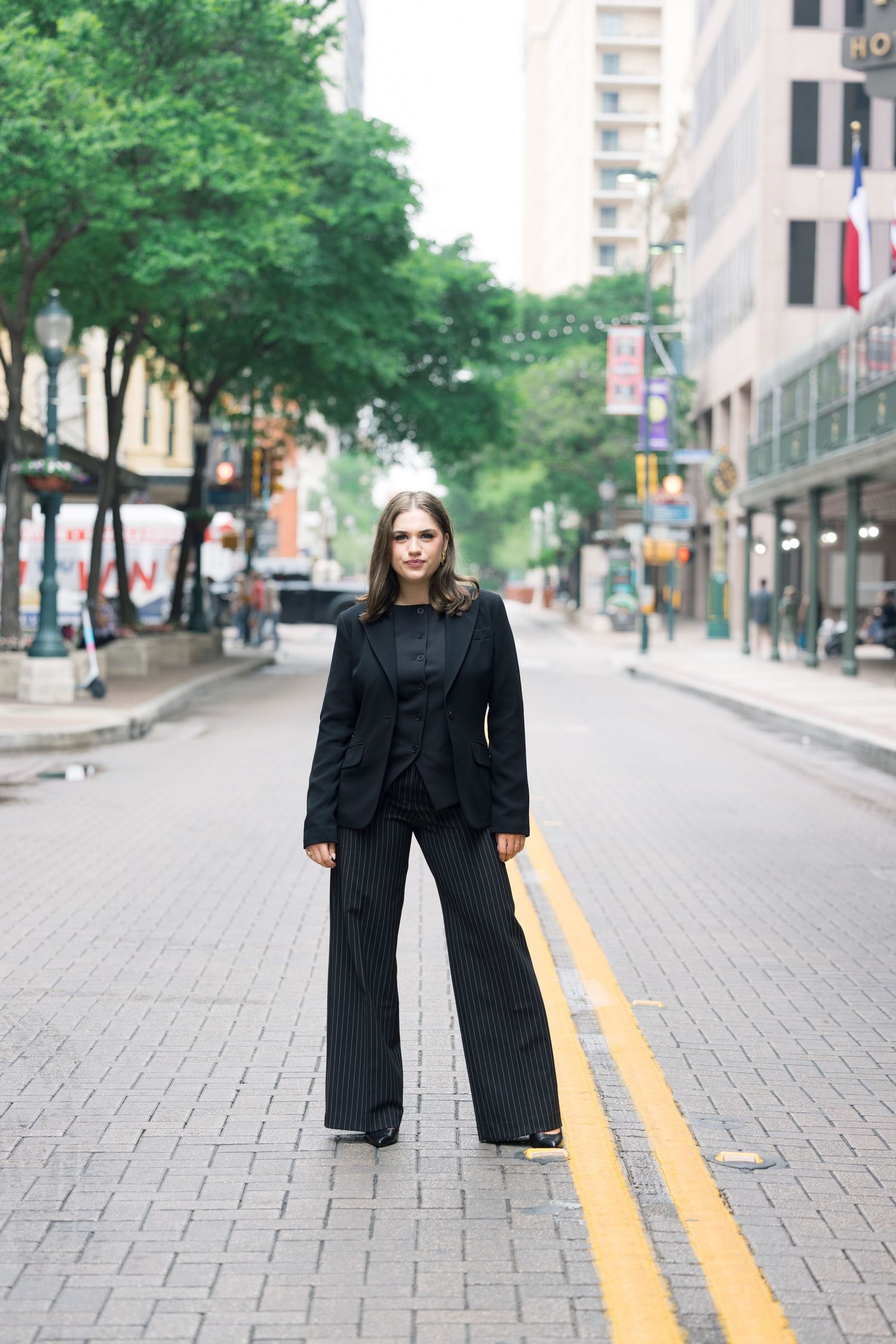Downtown street photography featuring black business attire against city architecture.