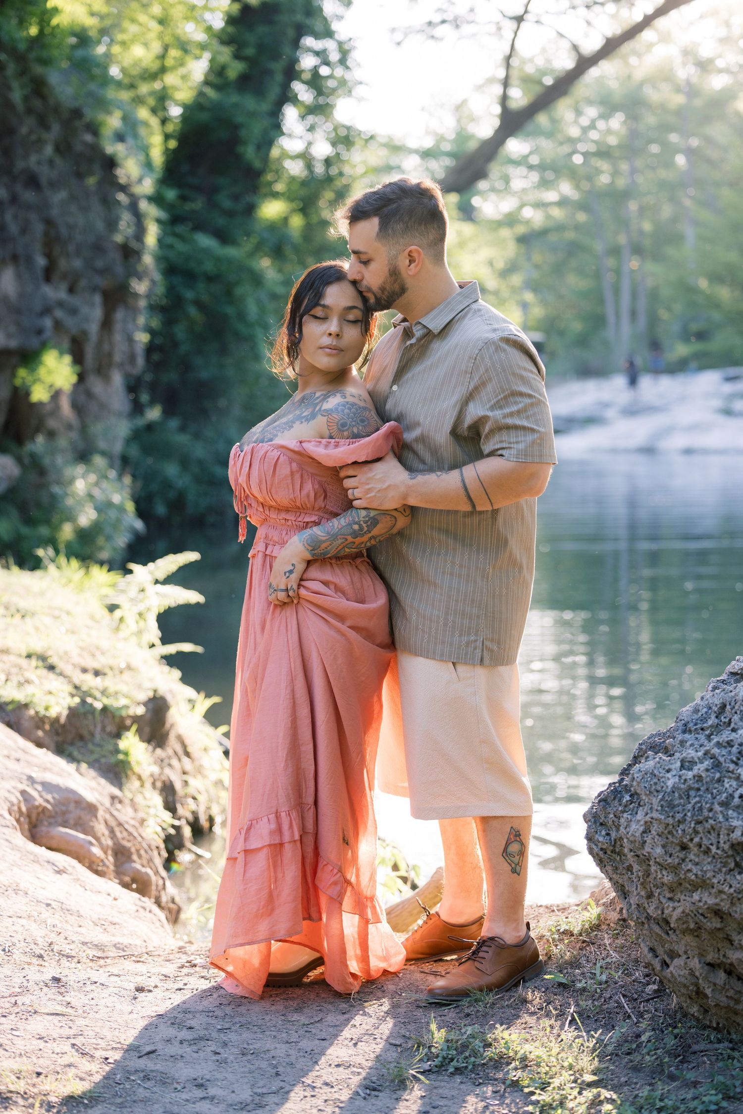Intimate couple's portraits captured in soft lighting by a peaceful lake setting.
