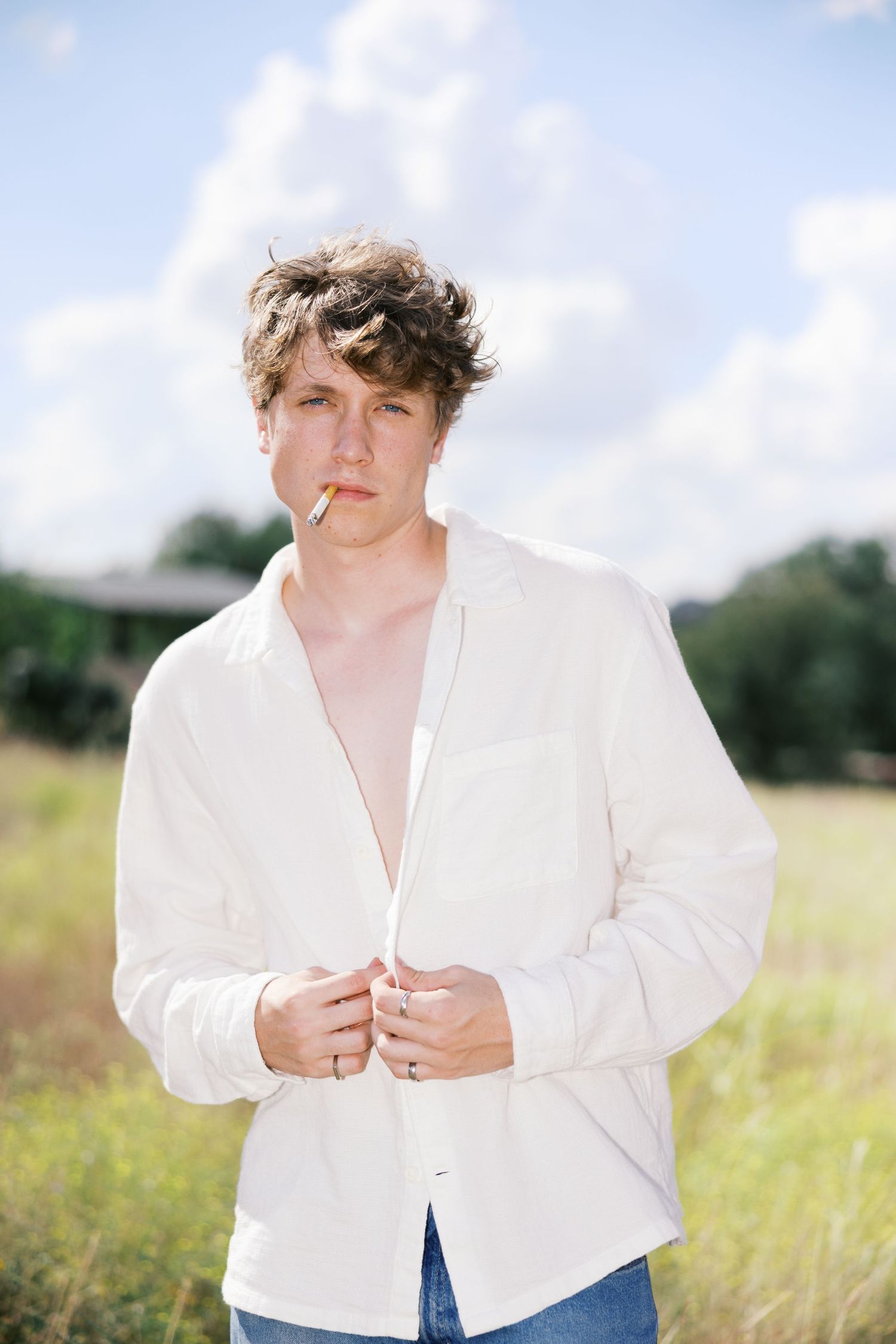 Natural light portrait in field showing white shirt styling details.