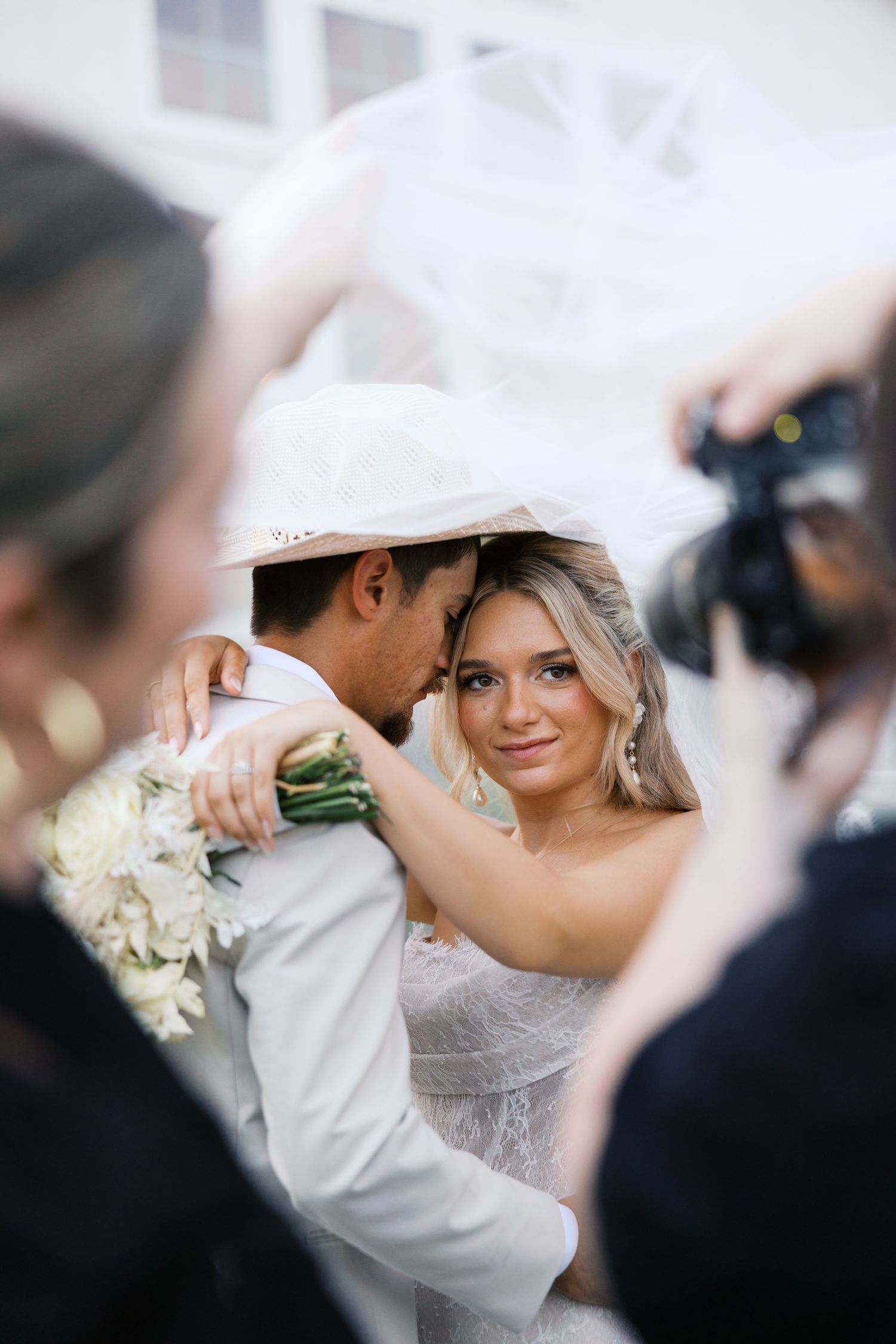 A romantic wedding dance sequence captured under a delicate white veil.