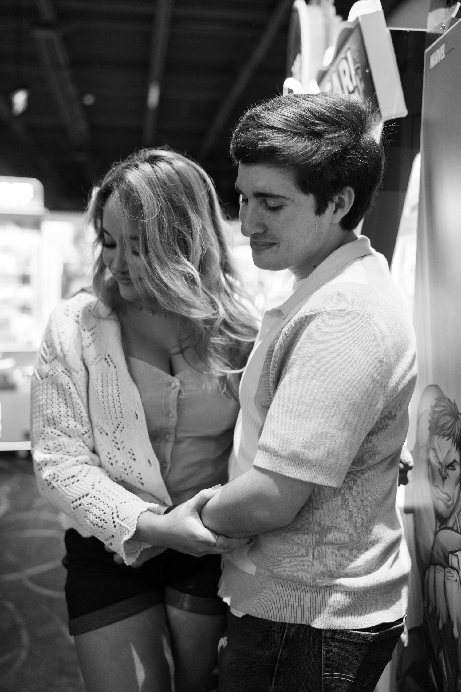 Intimate black and white photo of people in casual attire.