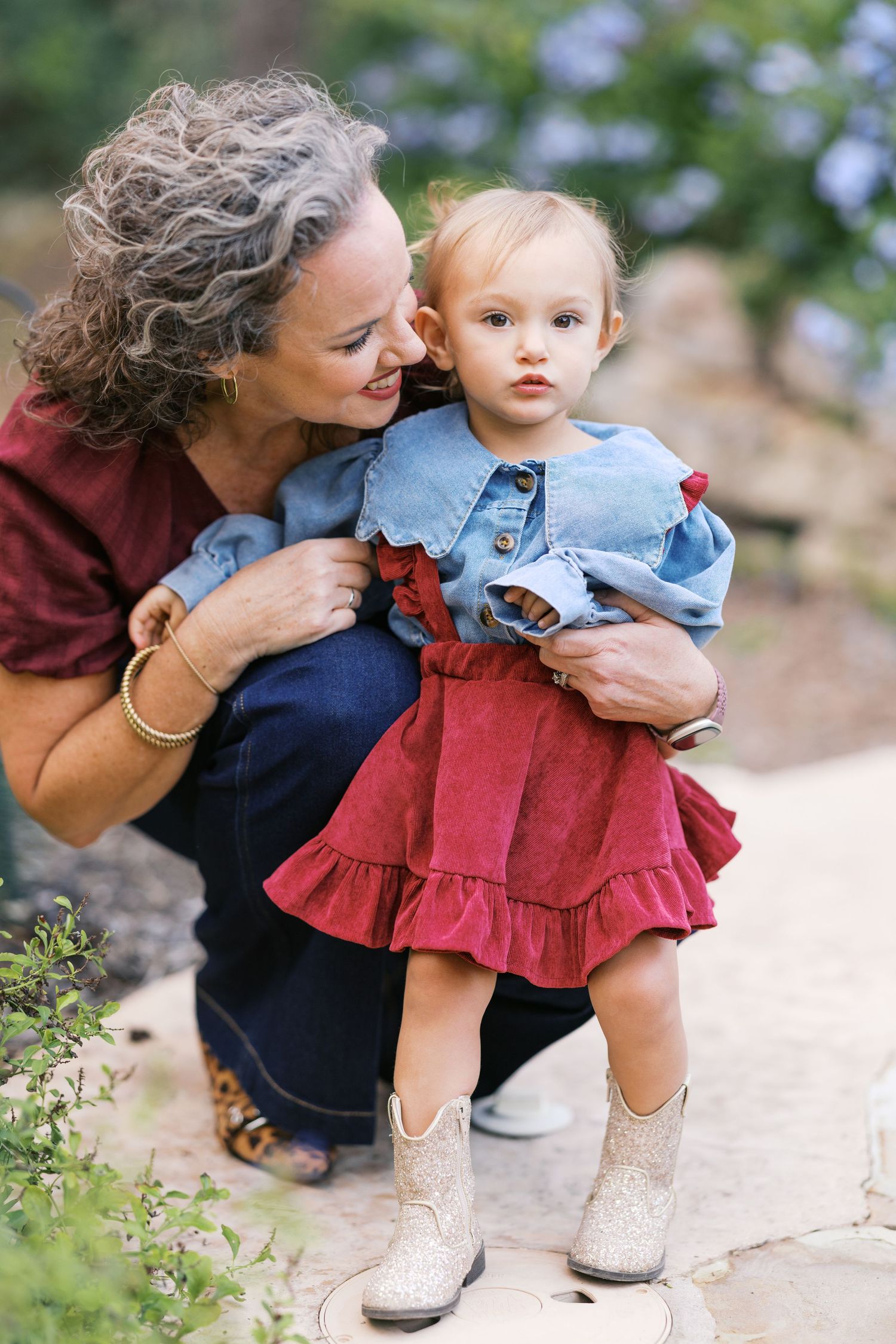 Sweet candid moments captured between family members on rocky outdoor terrain.