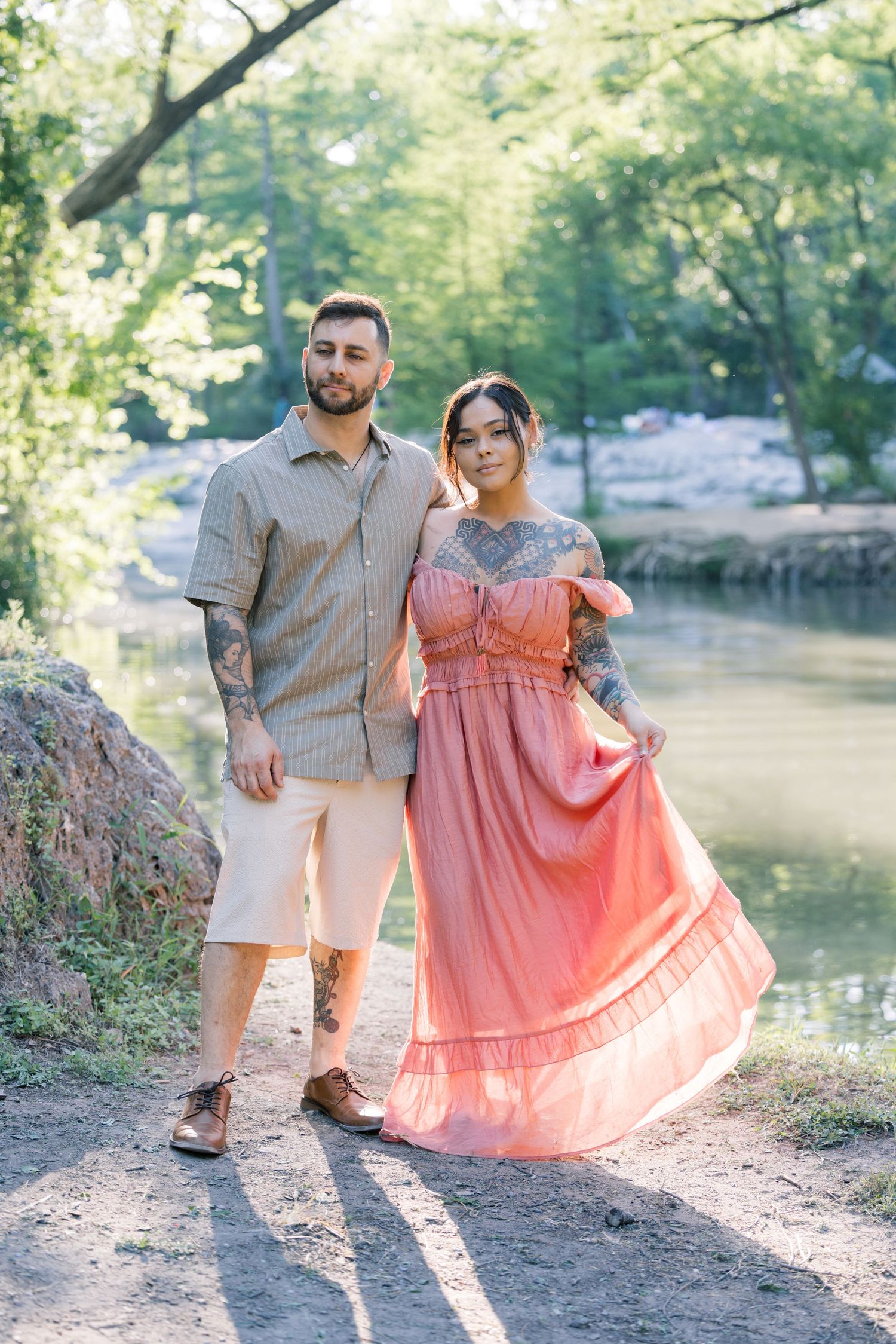 Sweet couple's photoshoot by a serene lake with the pair wearing coordinated spring colors.