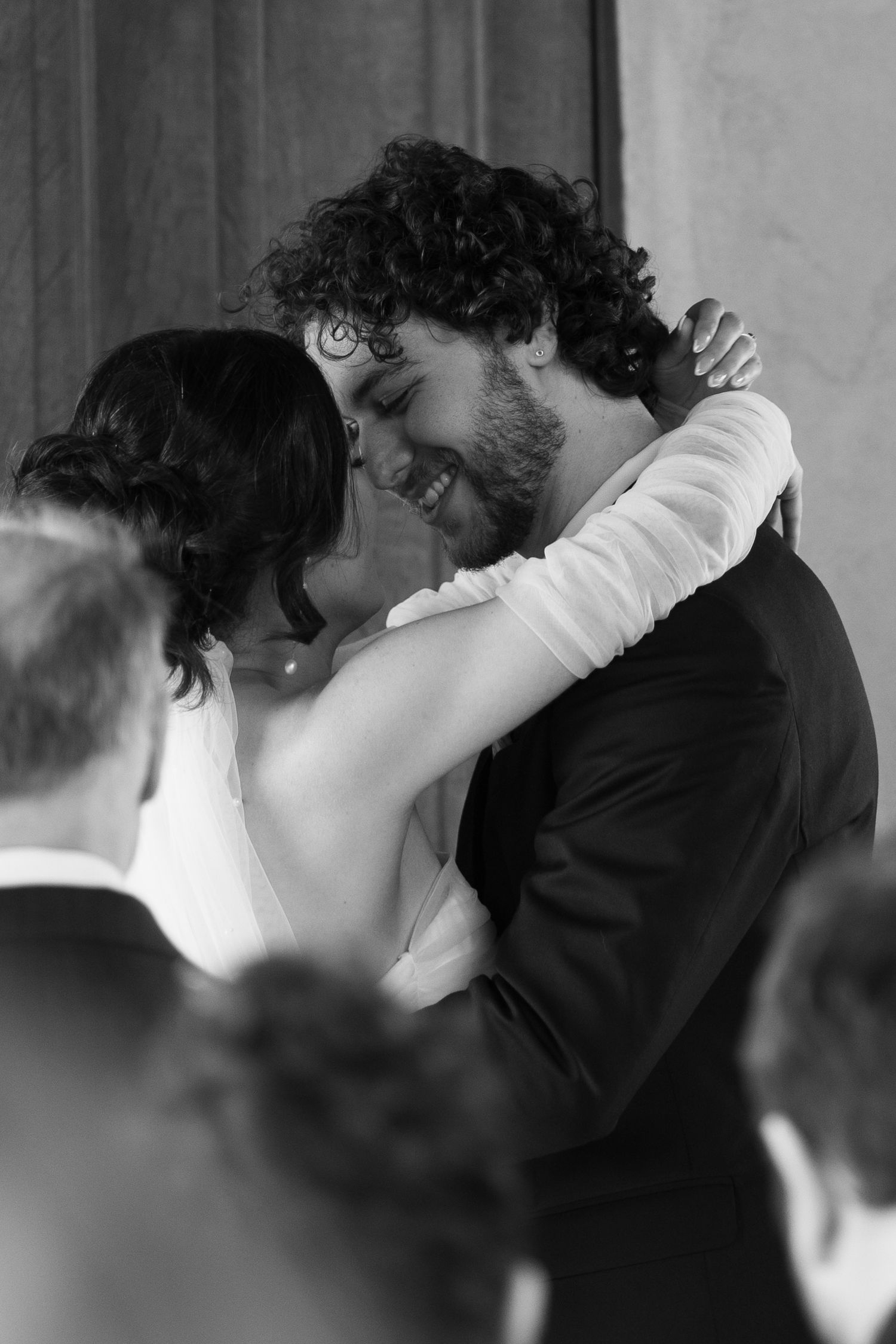 Black and white intimate moment between newlyweds during their wedding celebration.