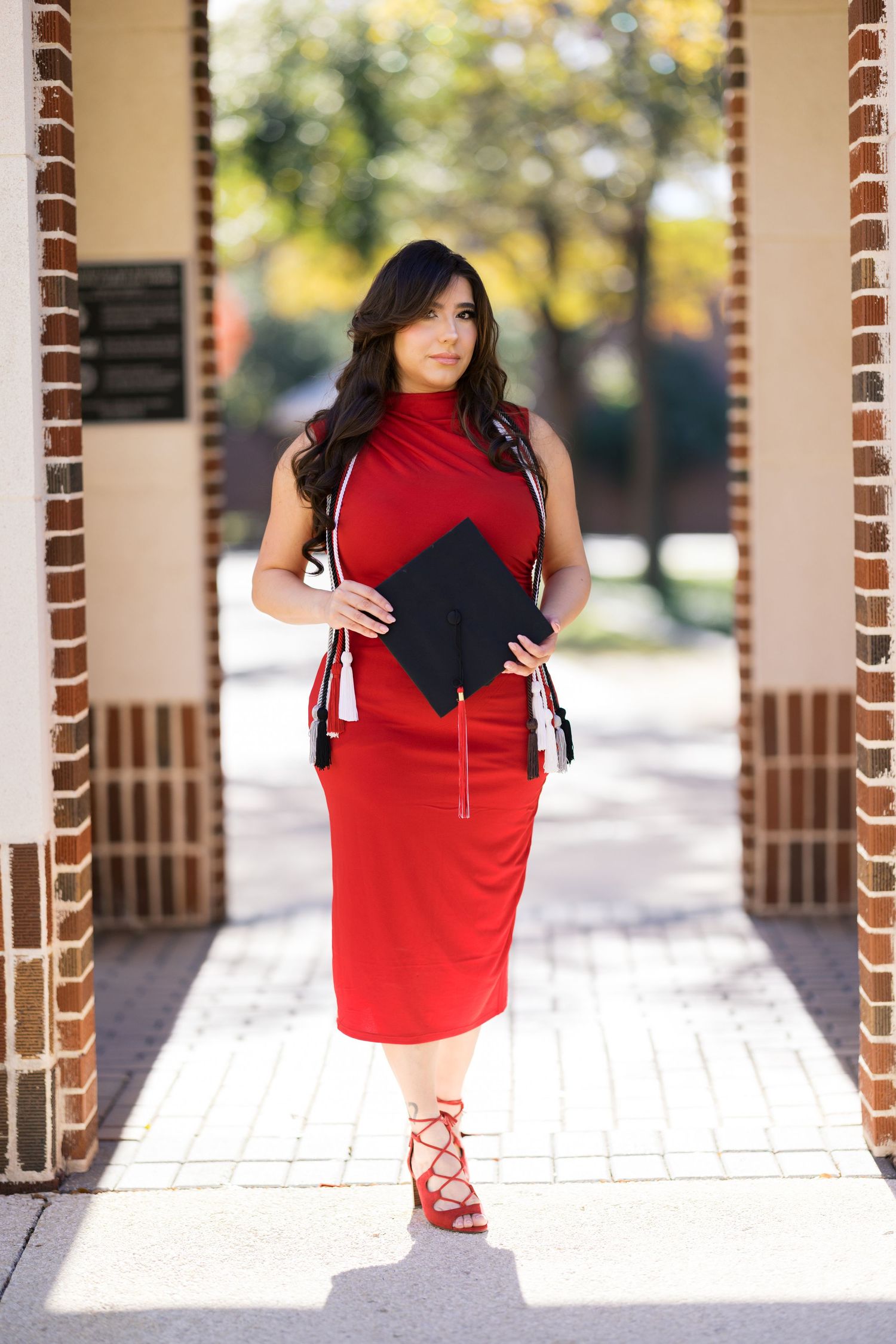 A striking red and black dress ensemble paired with lace-up sandals.