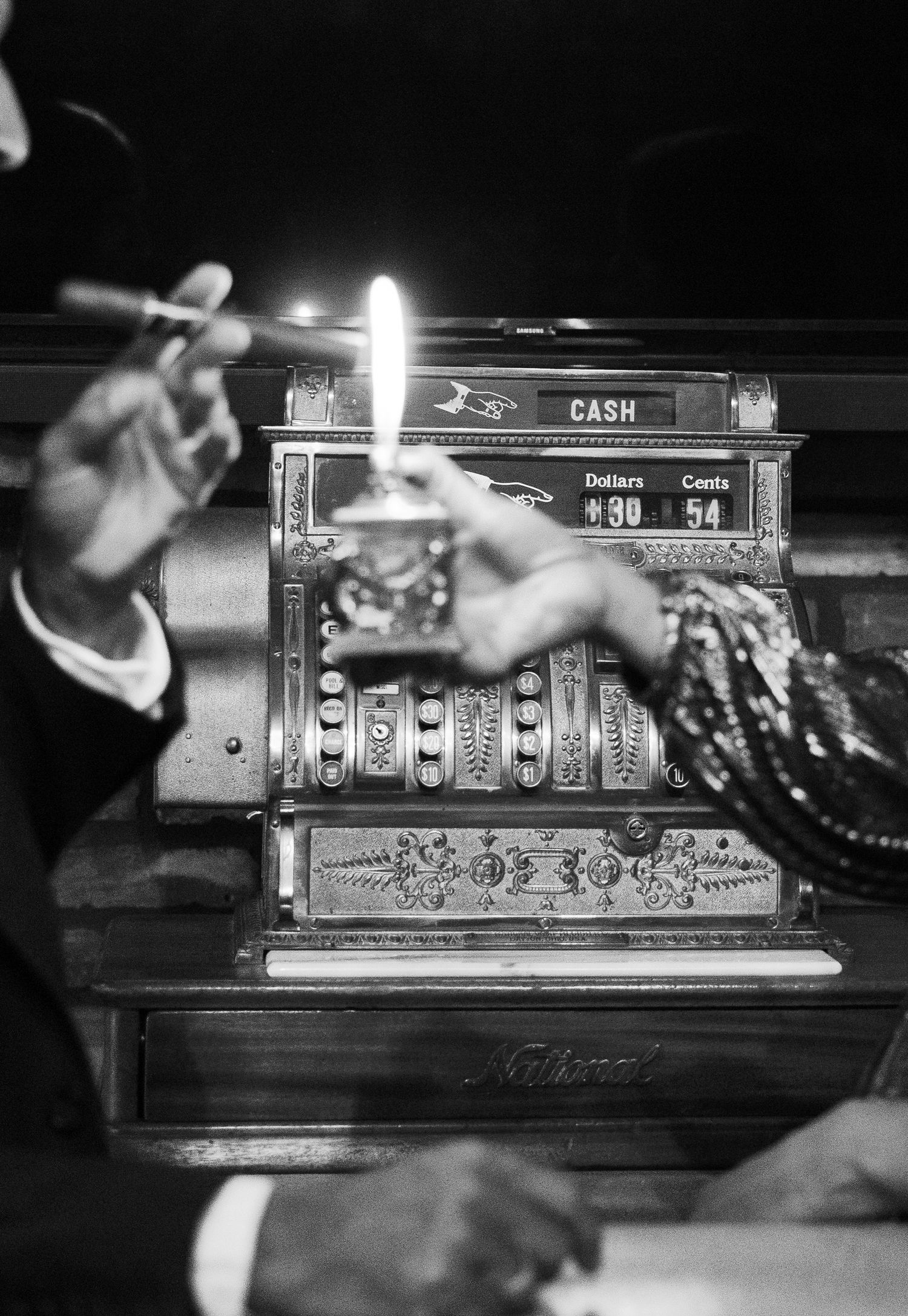 Vintage cash register mechanism showing internal mechanical parts and number displays in black and white.
