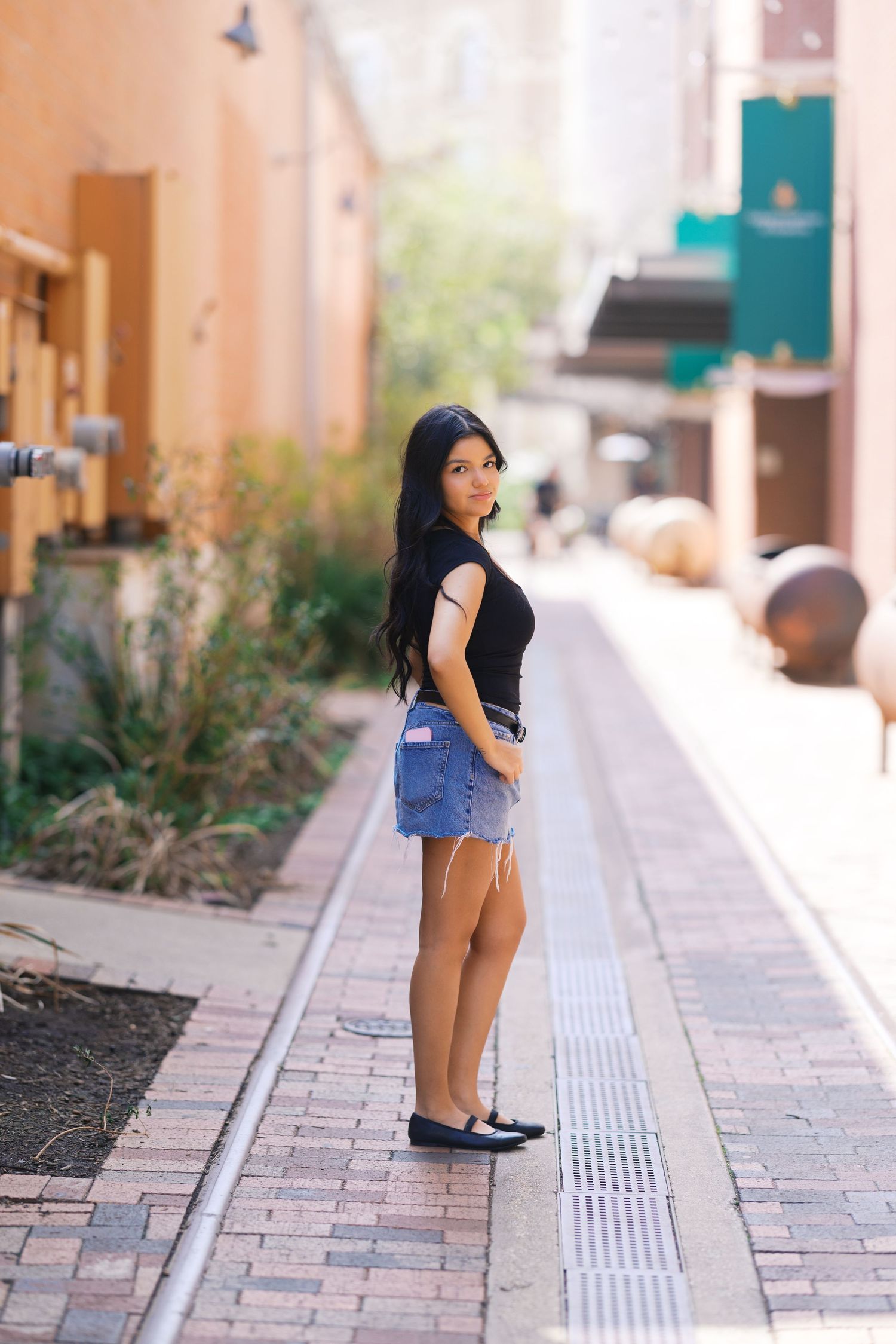 Casual outdoor portrait sequence showing poses along a Mediterranean-style walkway.