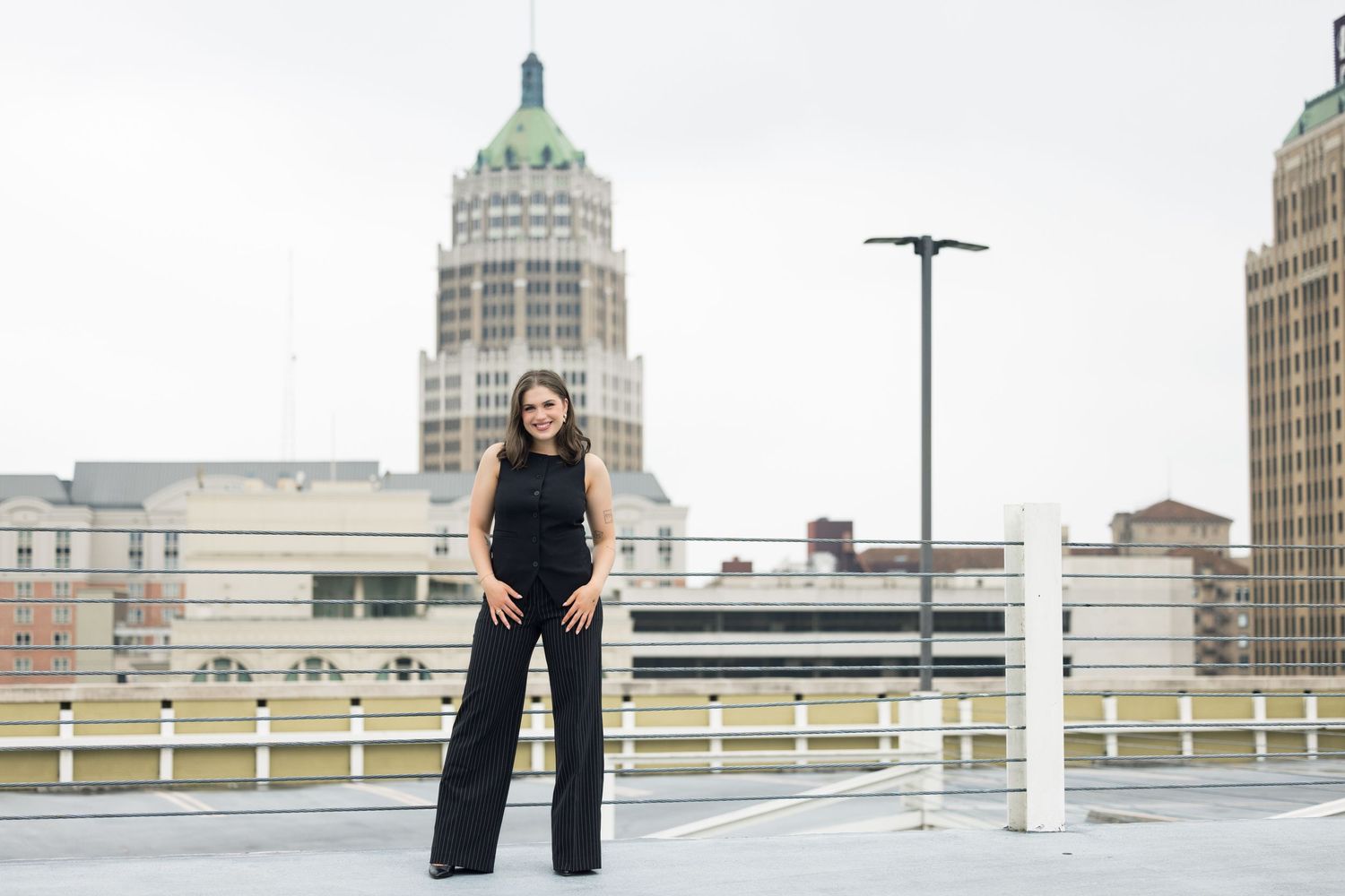 Urban fashion photography session with downtown buildings and rooftop setting.