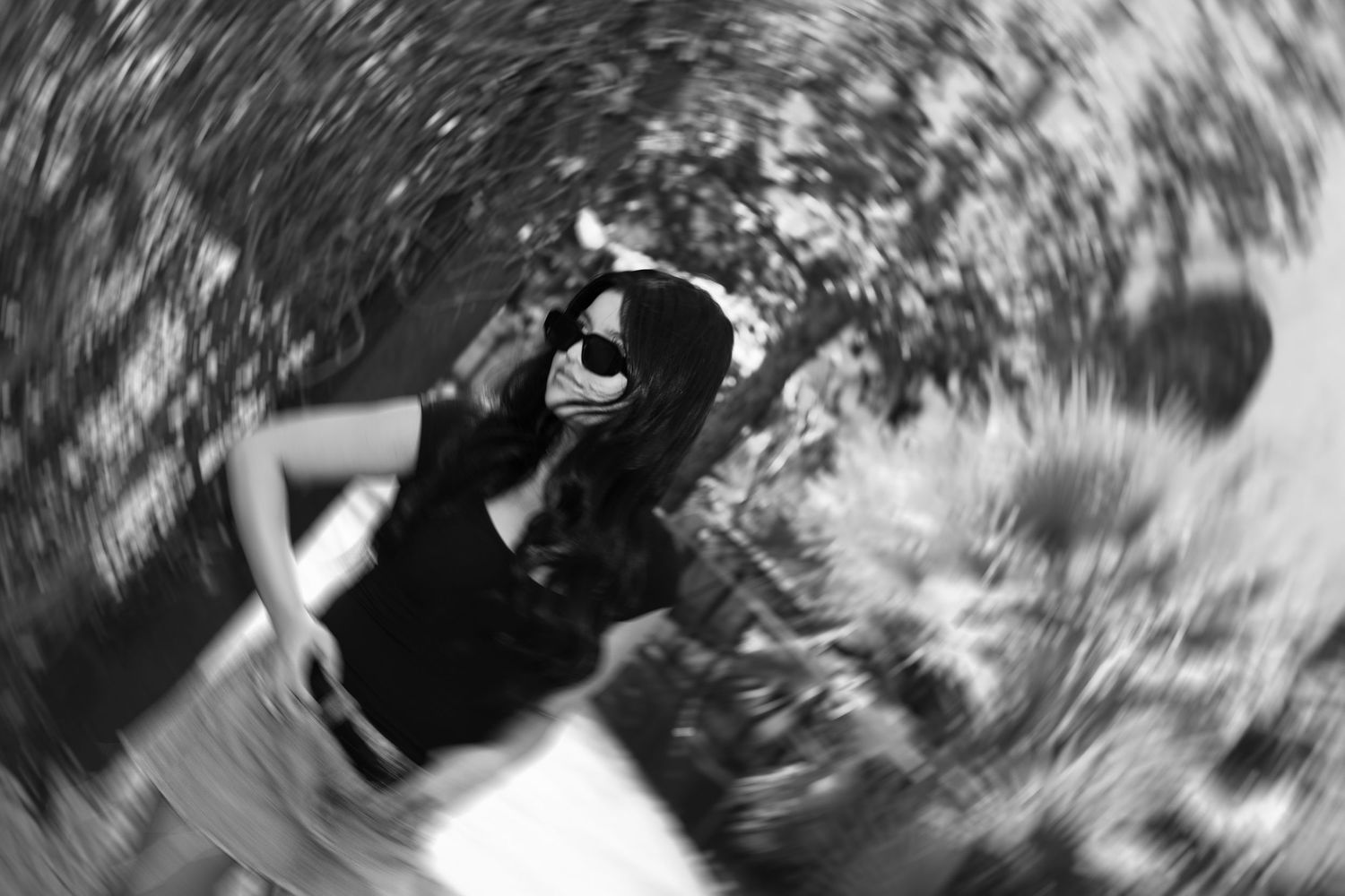 Artistic black and white swirled perspective shot of person in casual attire.