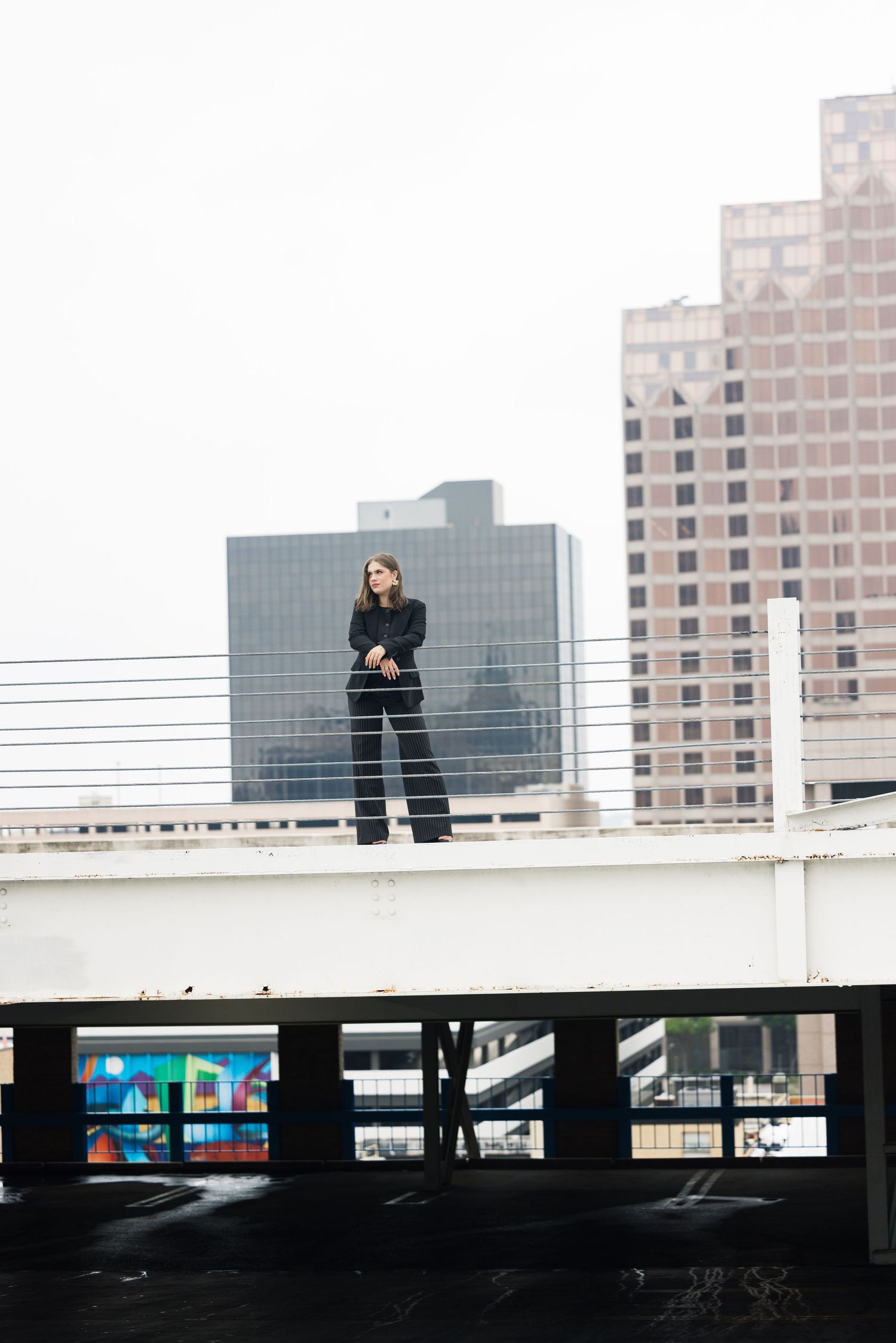 Artistic silhouette photograph on parking structure with downtown skyline.