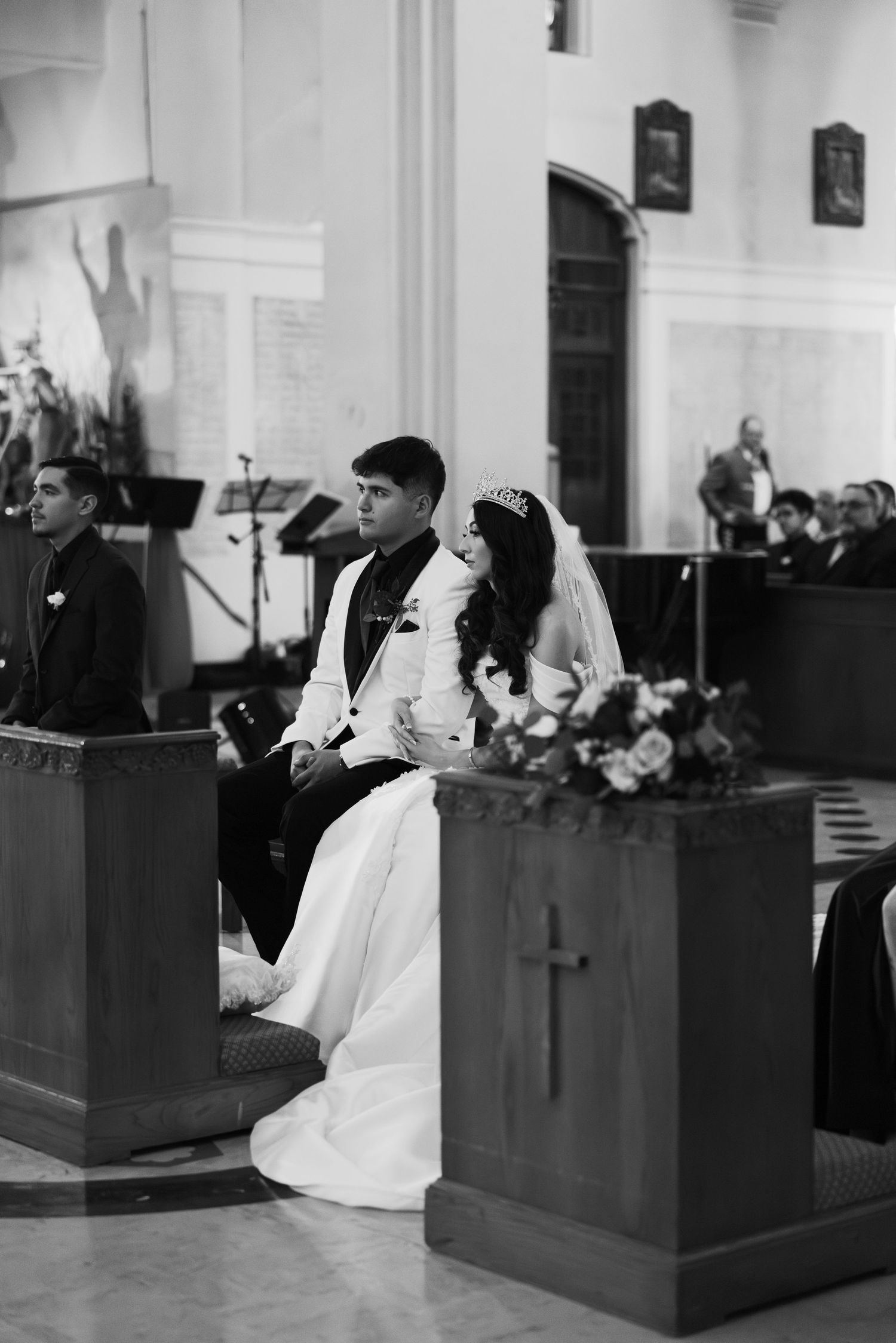 Black and white photograph of a wedding ceremony in progress at a traditional church altar.