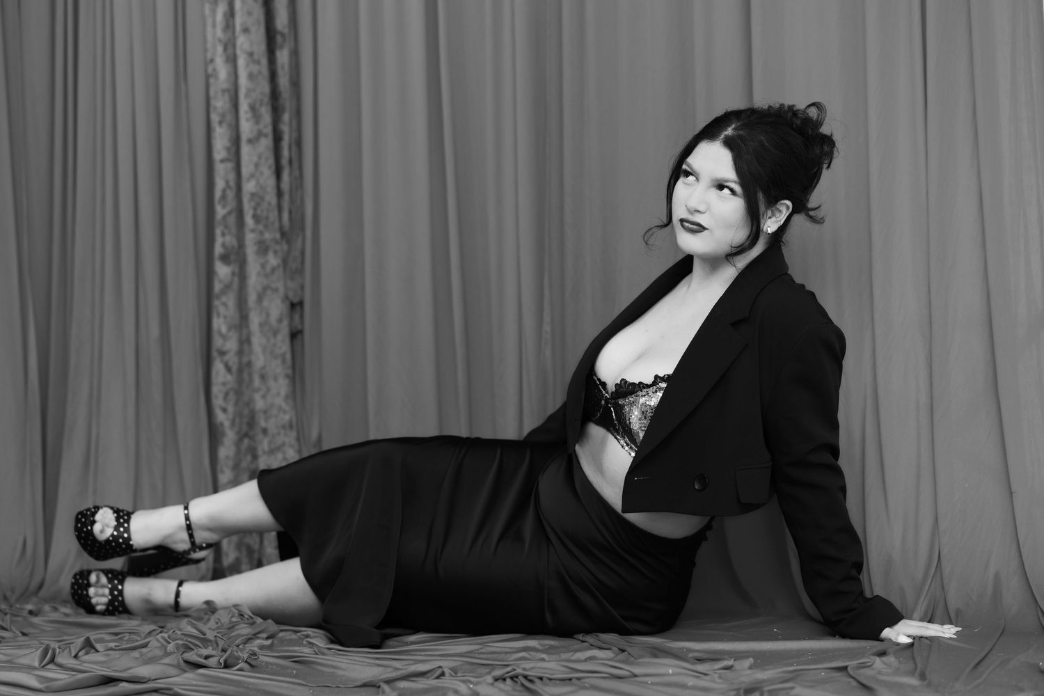 Artistic black and white portrait series on gray backdrop.
