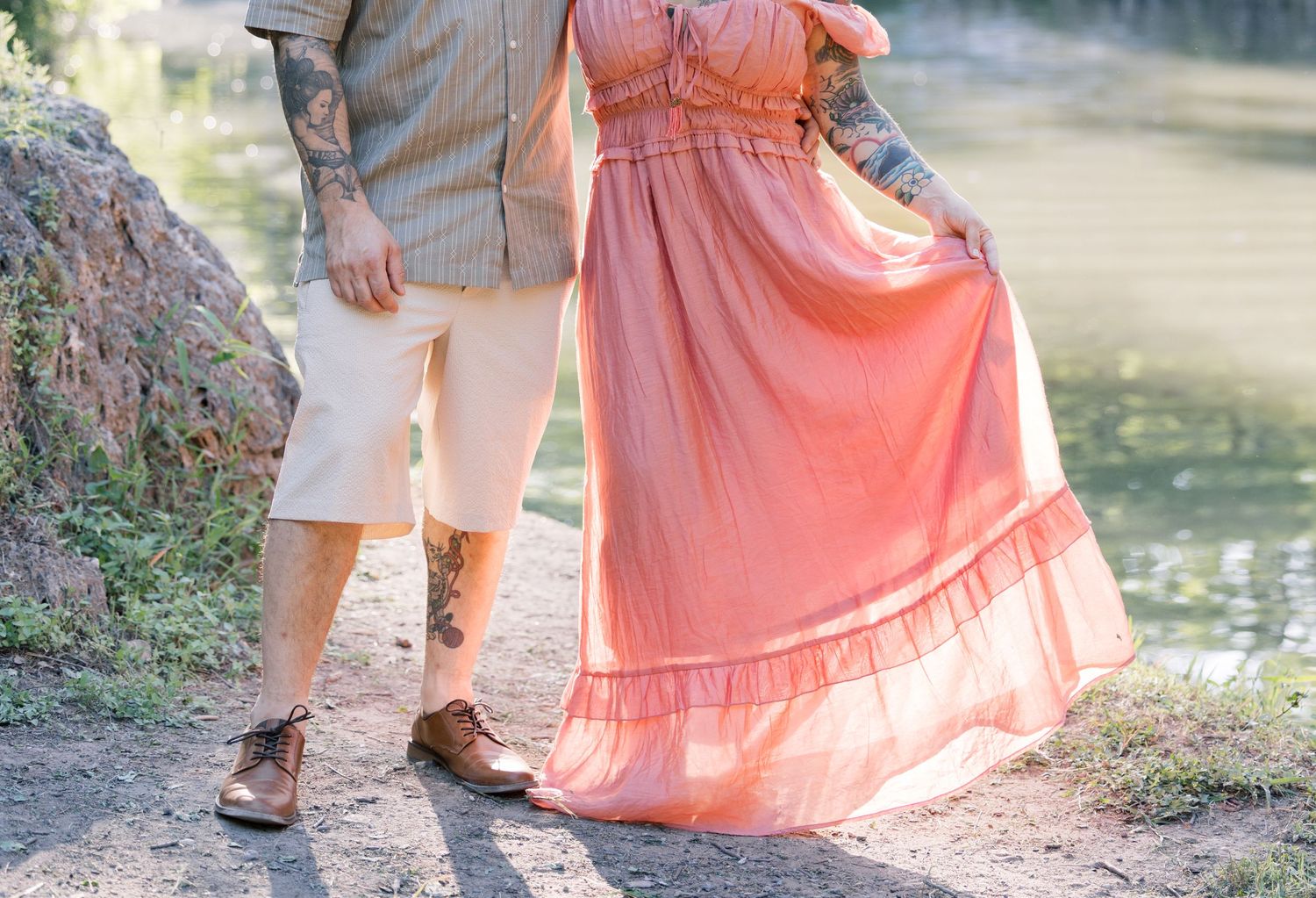 Romantic lakeside portraits showing a couple in matching pastel outfits against a natural backdrop.