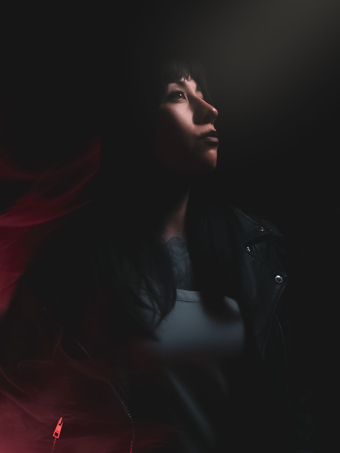 A moody, creative self portrait with cinematic lighting.