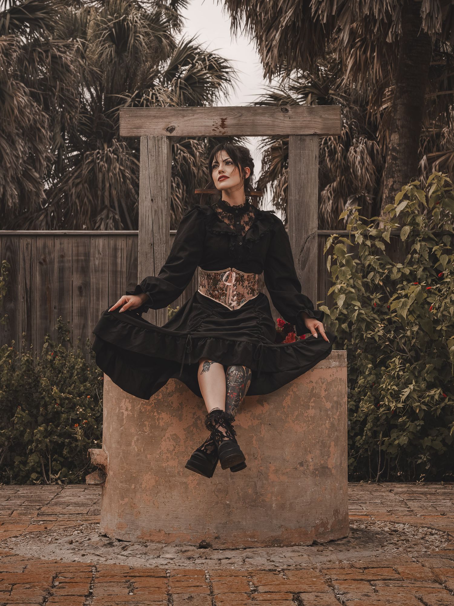 A low-key creative portrait of a model with light gothic aesthetic and natural lighting.