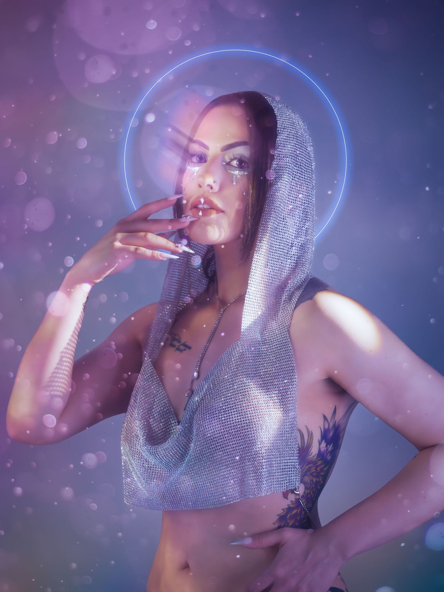Ethereal interstellar portrait featuring model with galaxy-inspired glitter makeup, soft pastel pink and purple creative lighting.