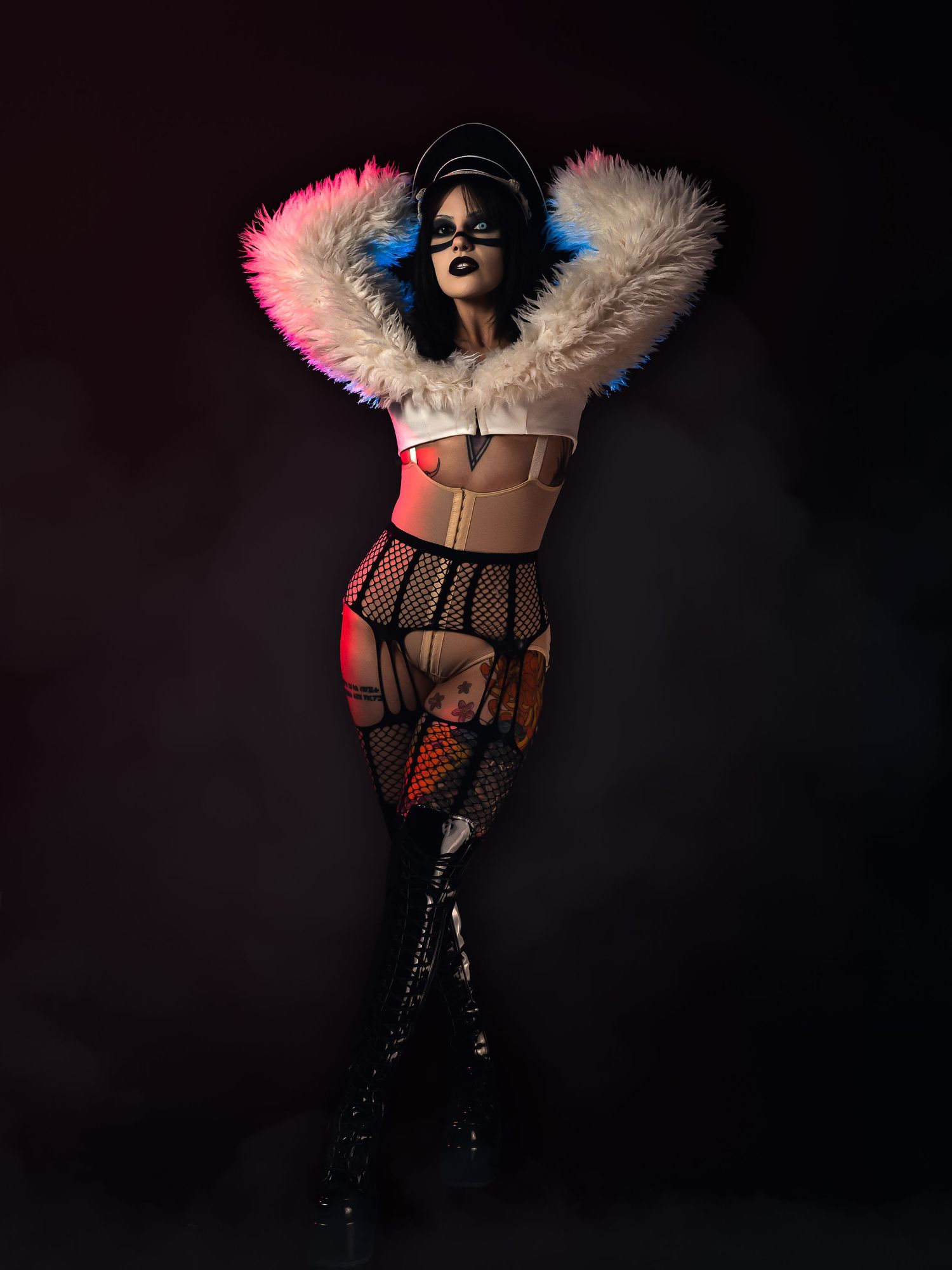 High-fashion portrait with bold magenta and electric blue creative lighting, 1990s industrial metal aesthetic, by JRange Photography.