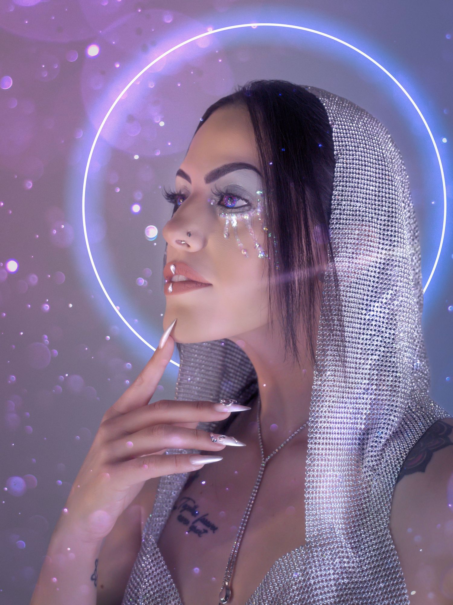 Ethereal interstellar portrait featuring model with galaxy-inspired glitter makeup, soft pastel pink and purple creative lighting.