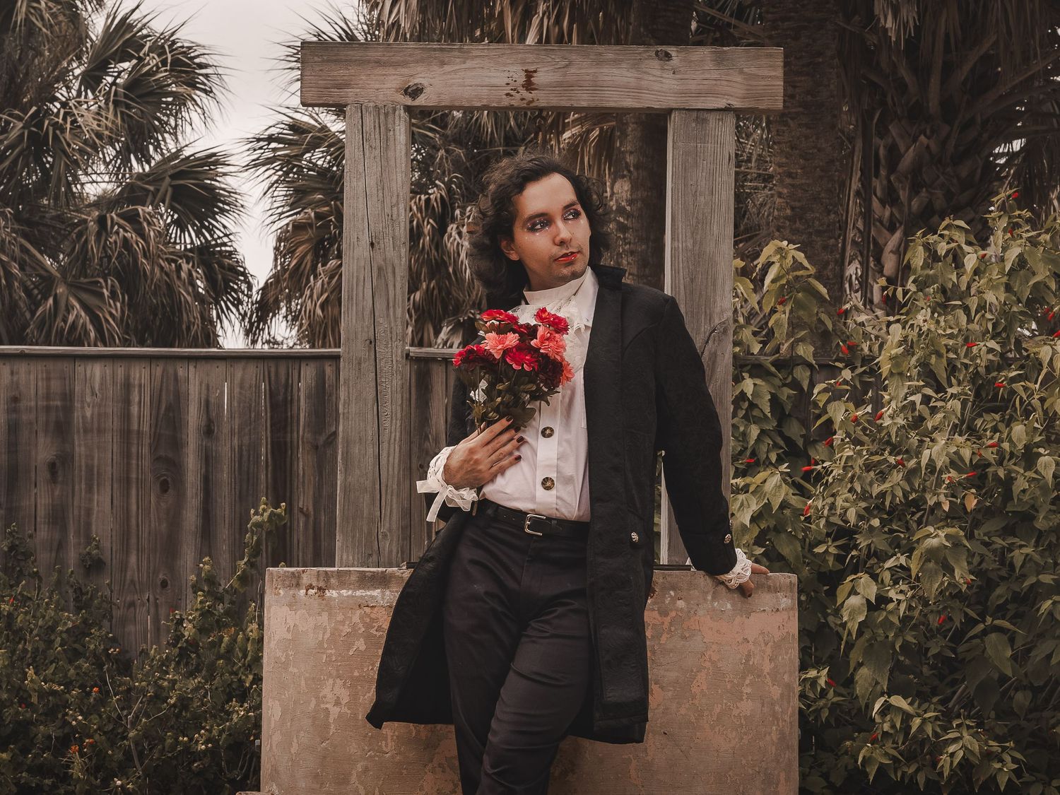 A low-key creative portrait of a model with light gothic aesthetic and natural lighting.