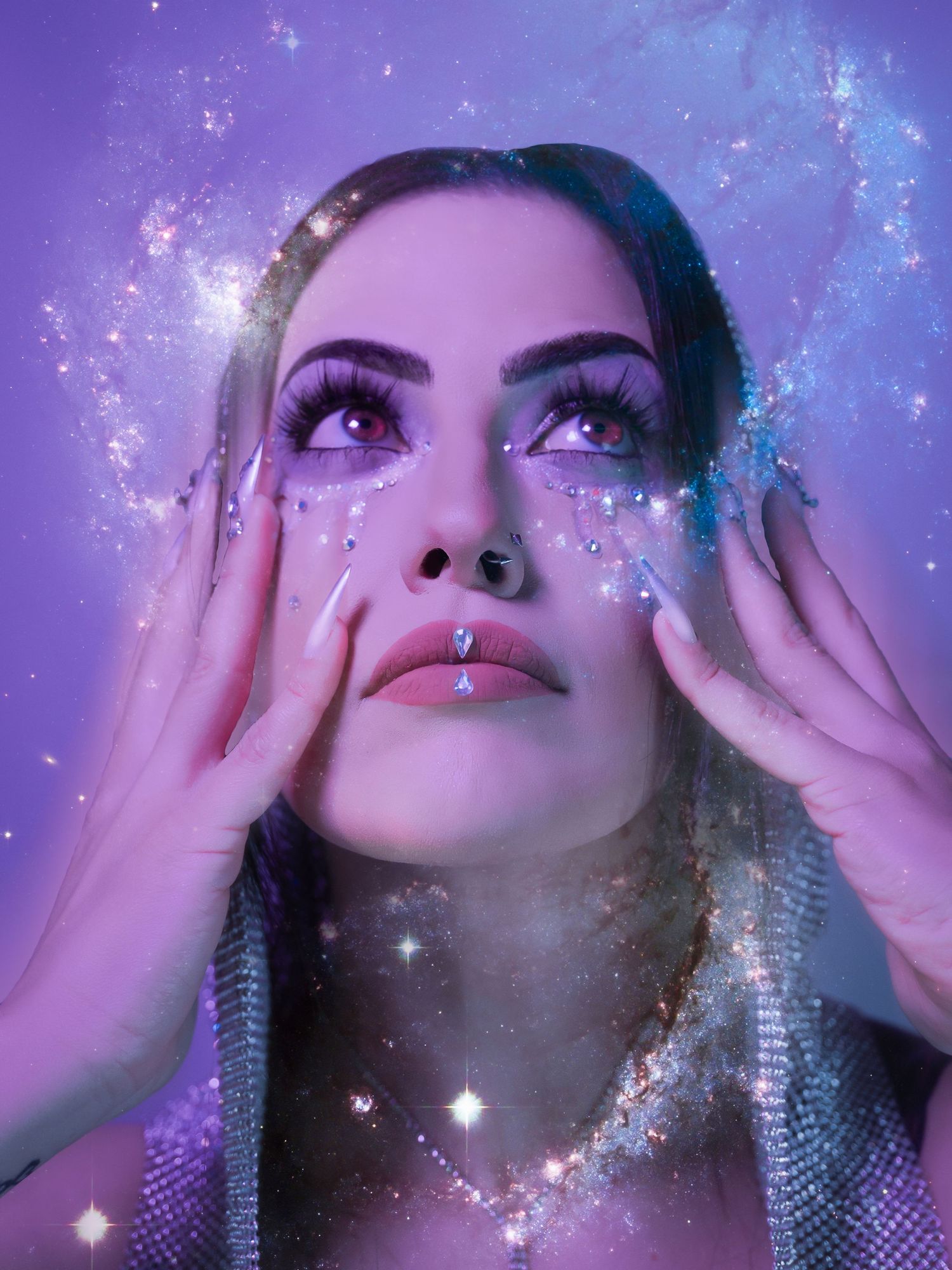 Ethereal interstellar portrait featuring model with galaxy-inspired glitter makeup, soft pastel pink and purple creative lighting.