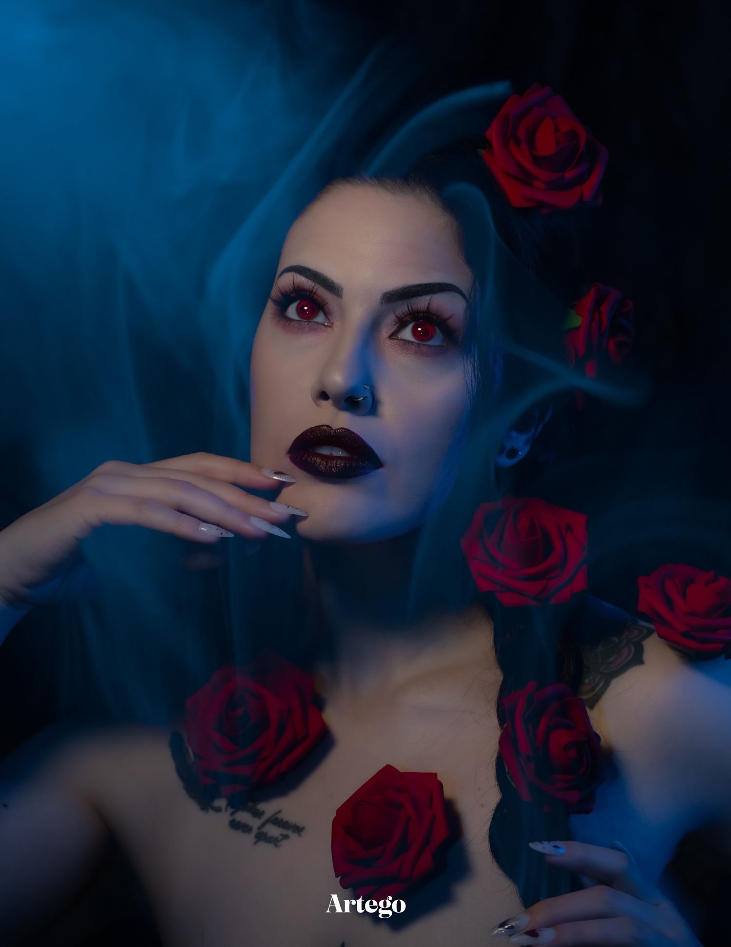 A moody, creative portrait of a model with a gothic aesthetic and dramatic lighting.