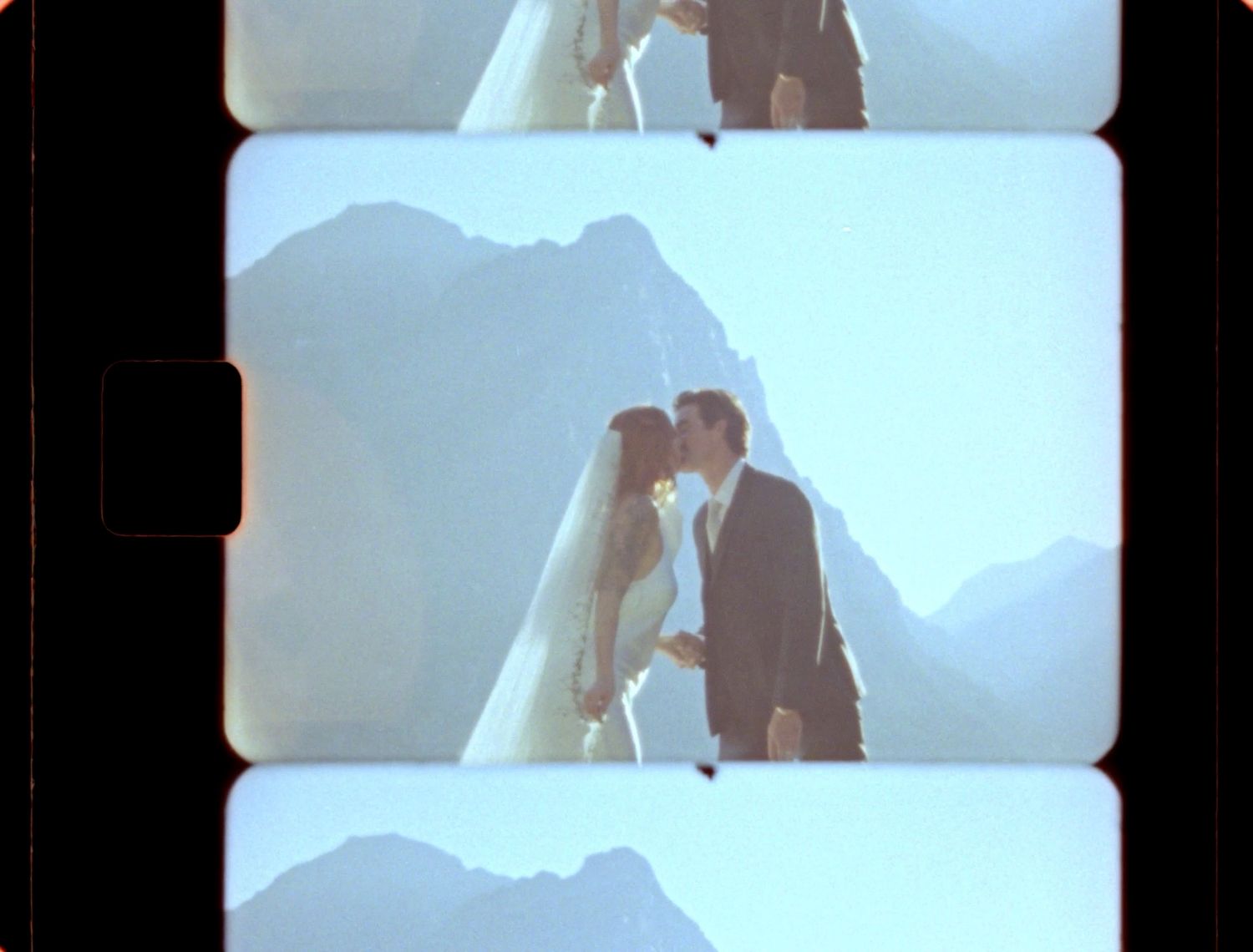 super 8 still of couple kissing in glacier national park at logan's pass