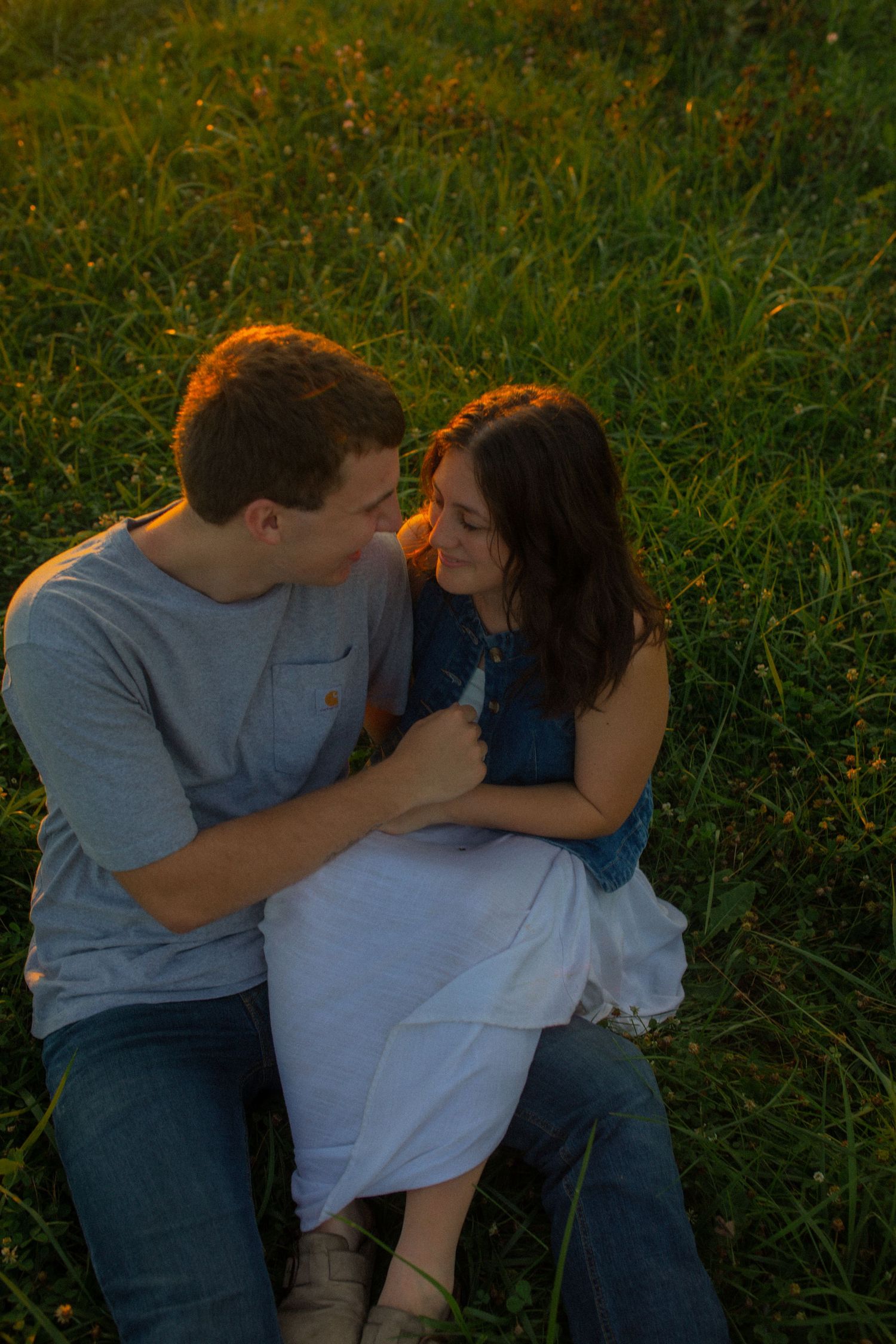 young adventurous couple holding each other during sunset in iowa