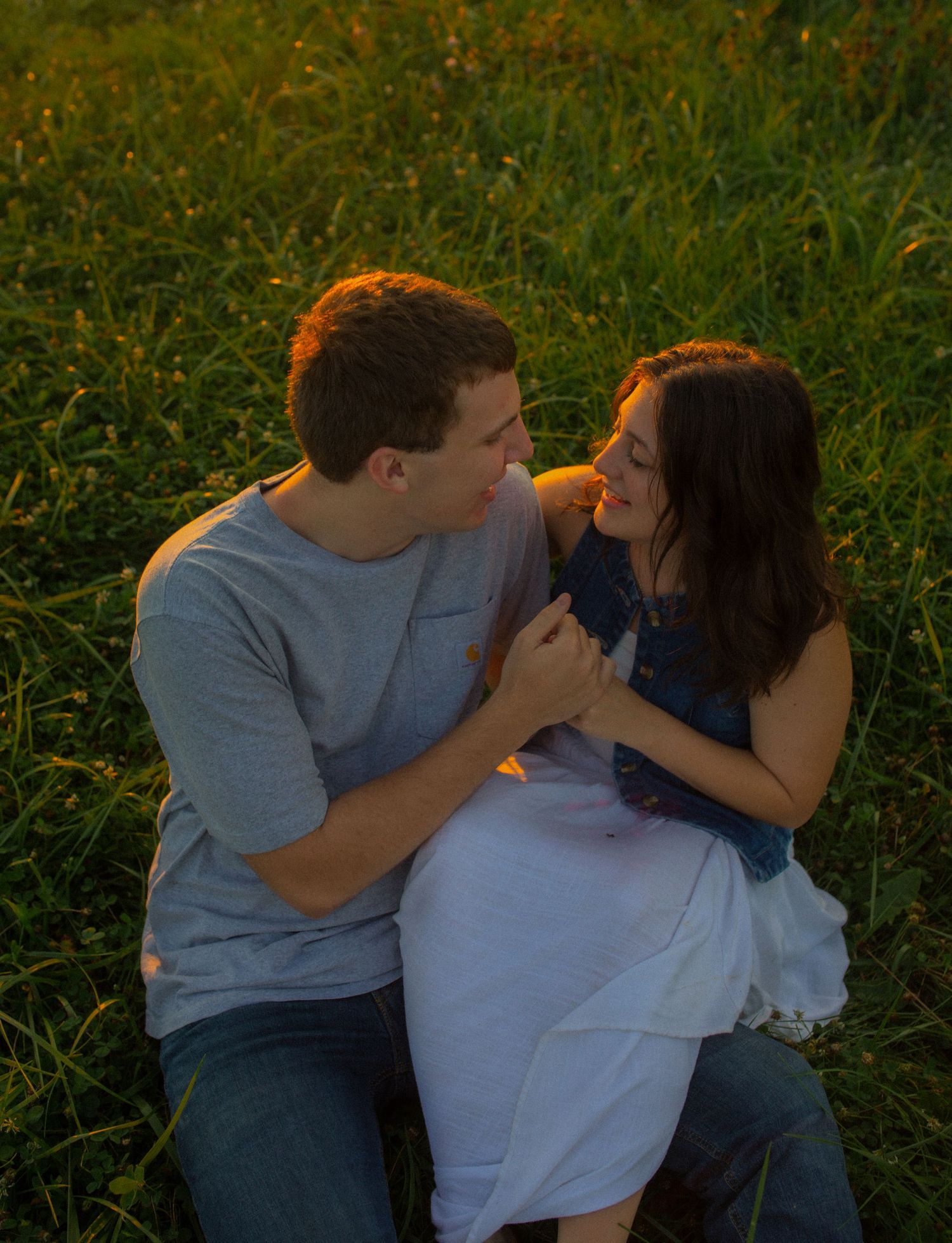 young adventurous couple holding each other during sunset in iowa