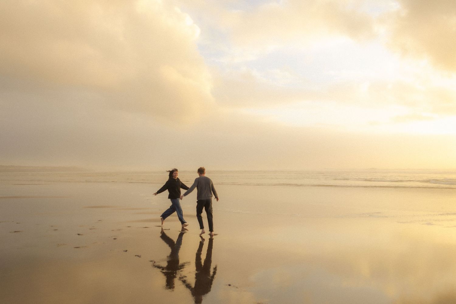adventurous couple on oregon coast during sunset