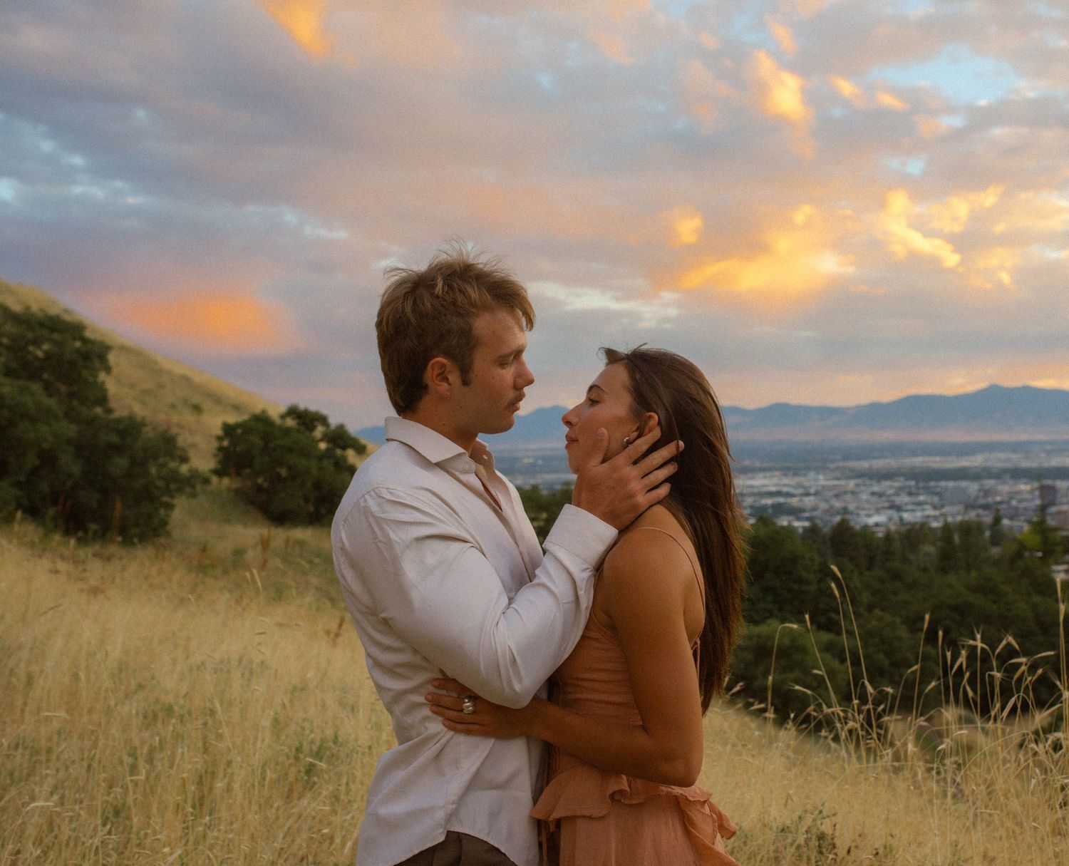 man holds woman's face during sunset in salt lake city Utah