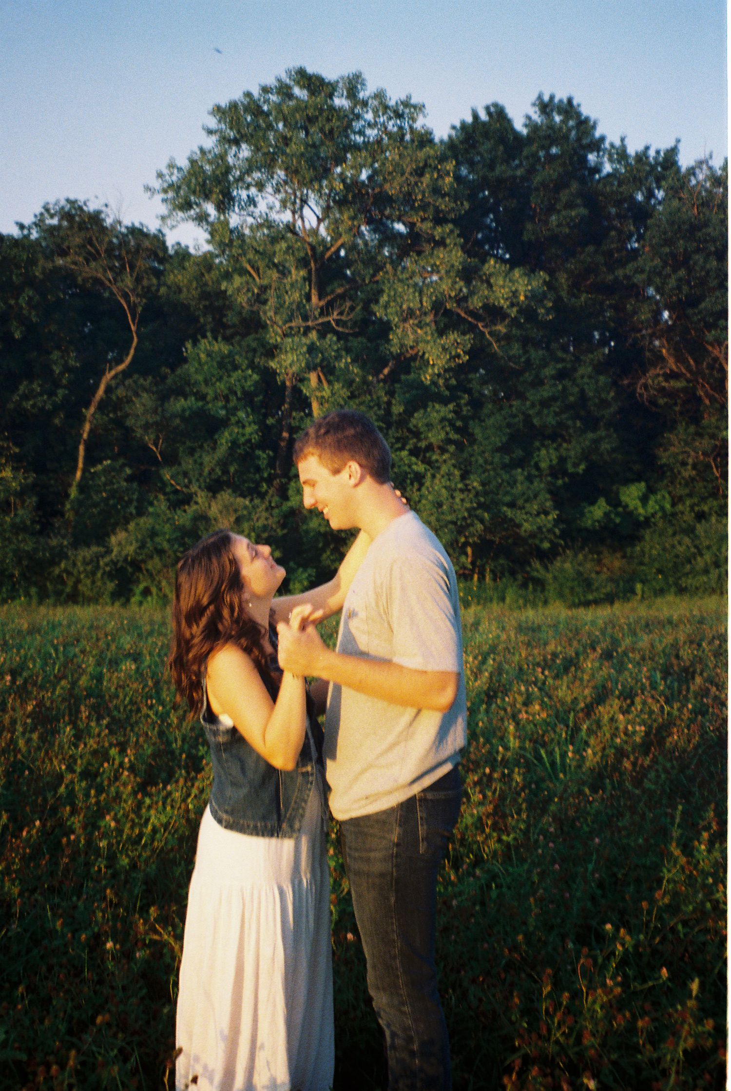 35mm film of young adventurous couple holding each other during sunset