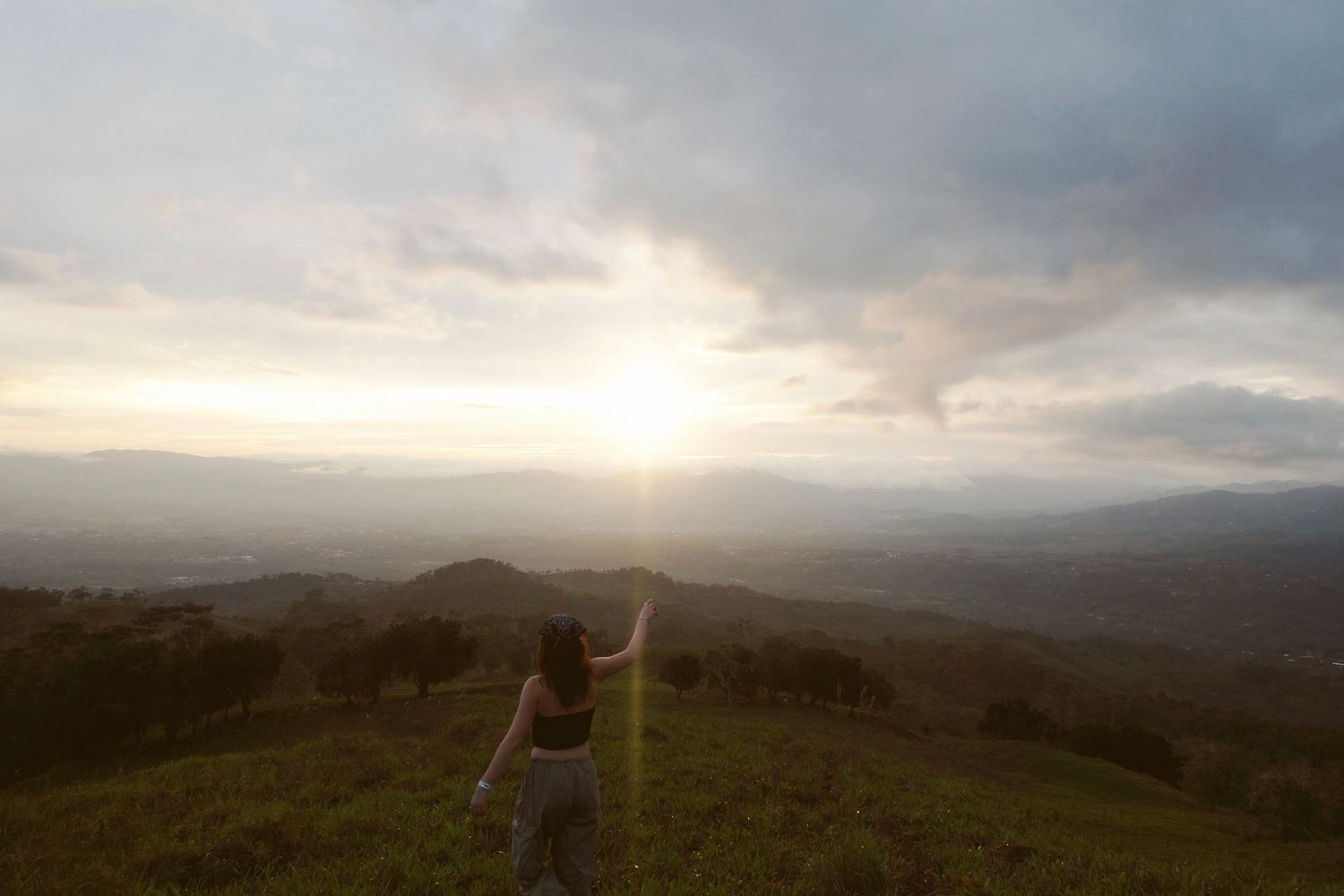 photo of girl in costa rica on mountain during sunset