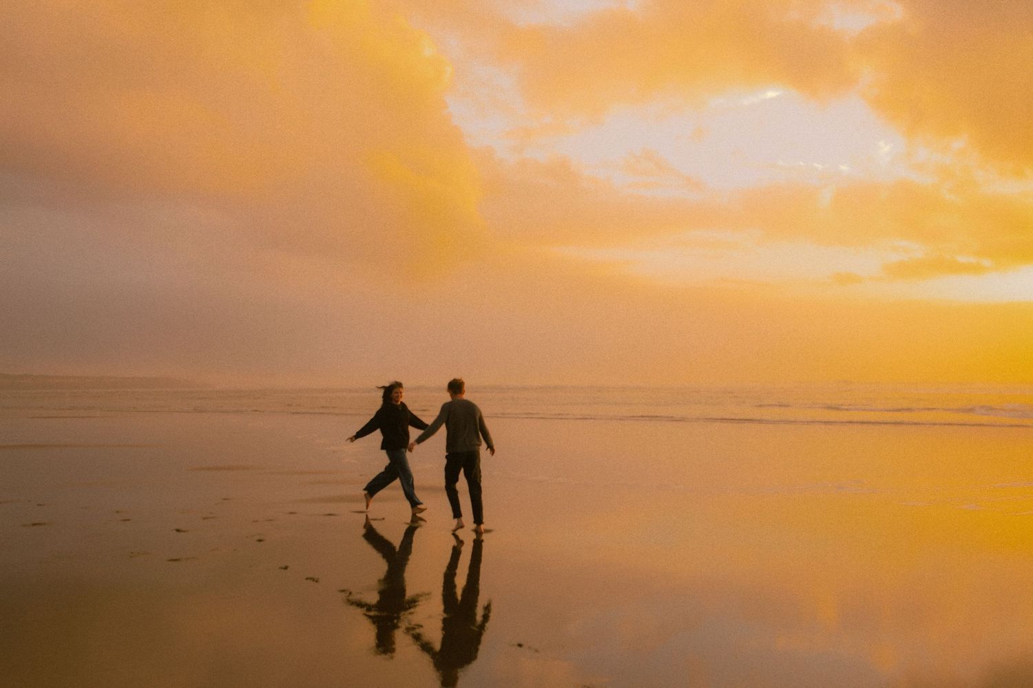 adventurous couple on oregon coast during sunset
