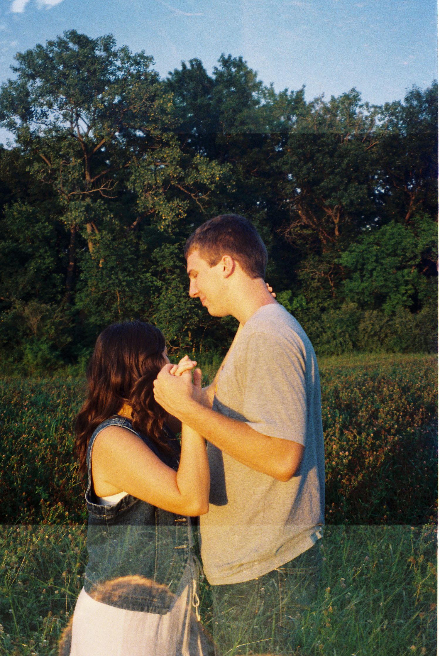 35mm film of young adventurous couple holding each other during sunset