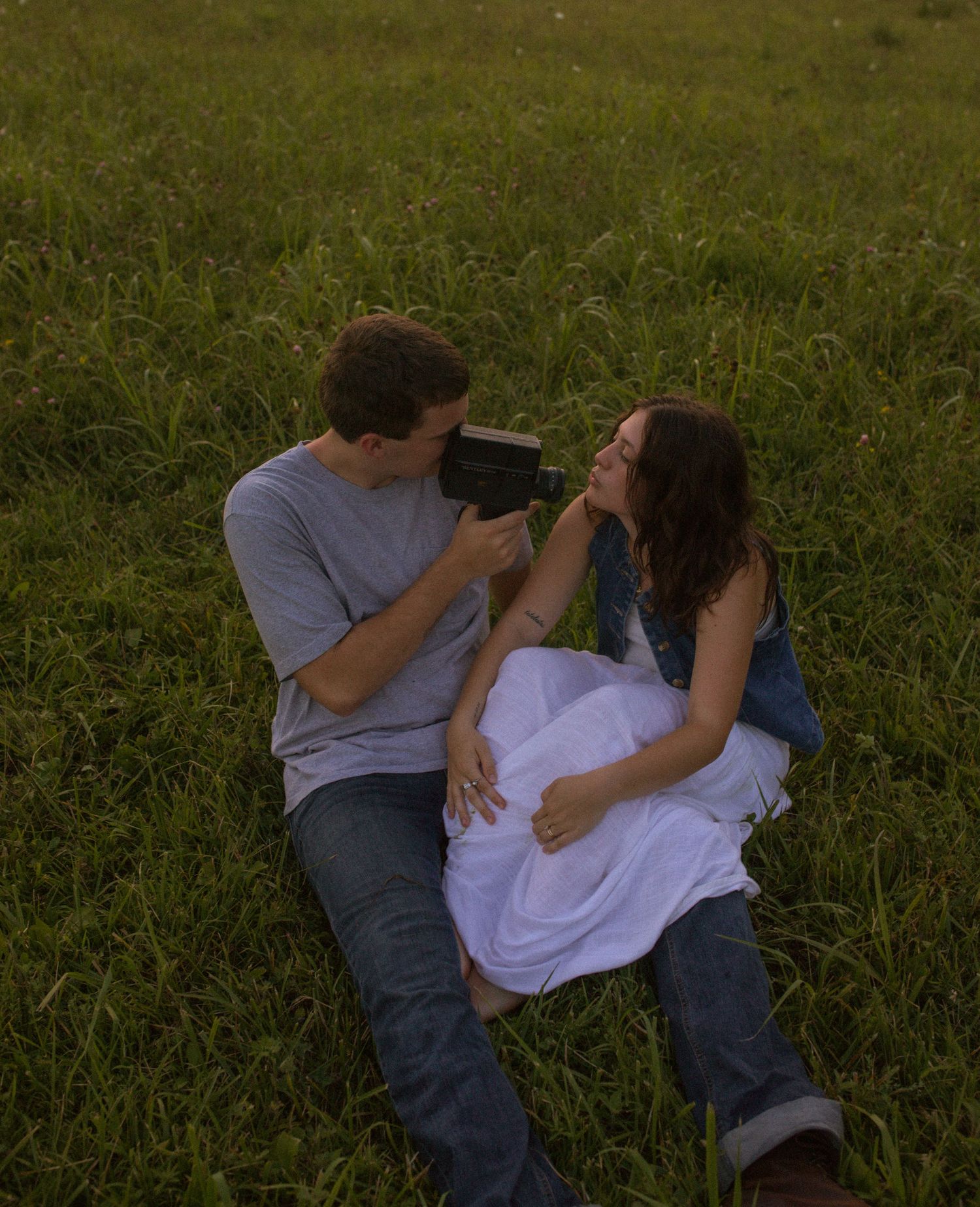 young adventurous couple holding each other during sunset in iowa