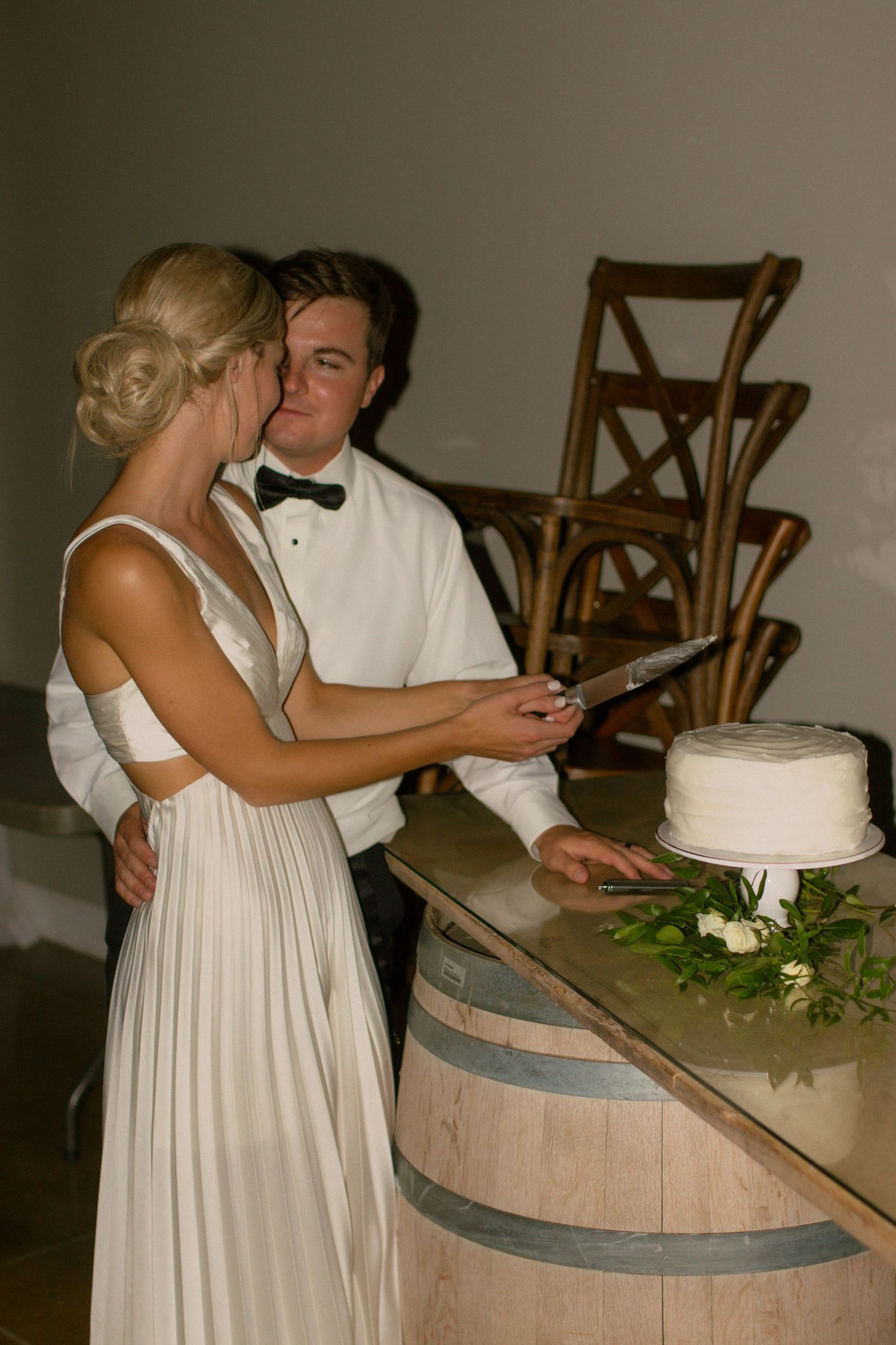 couple cuts cake during reception